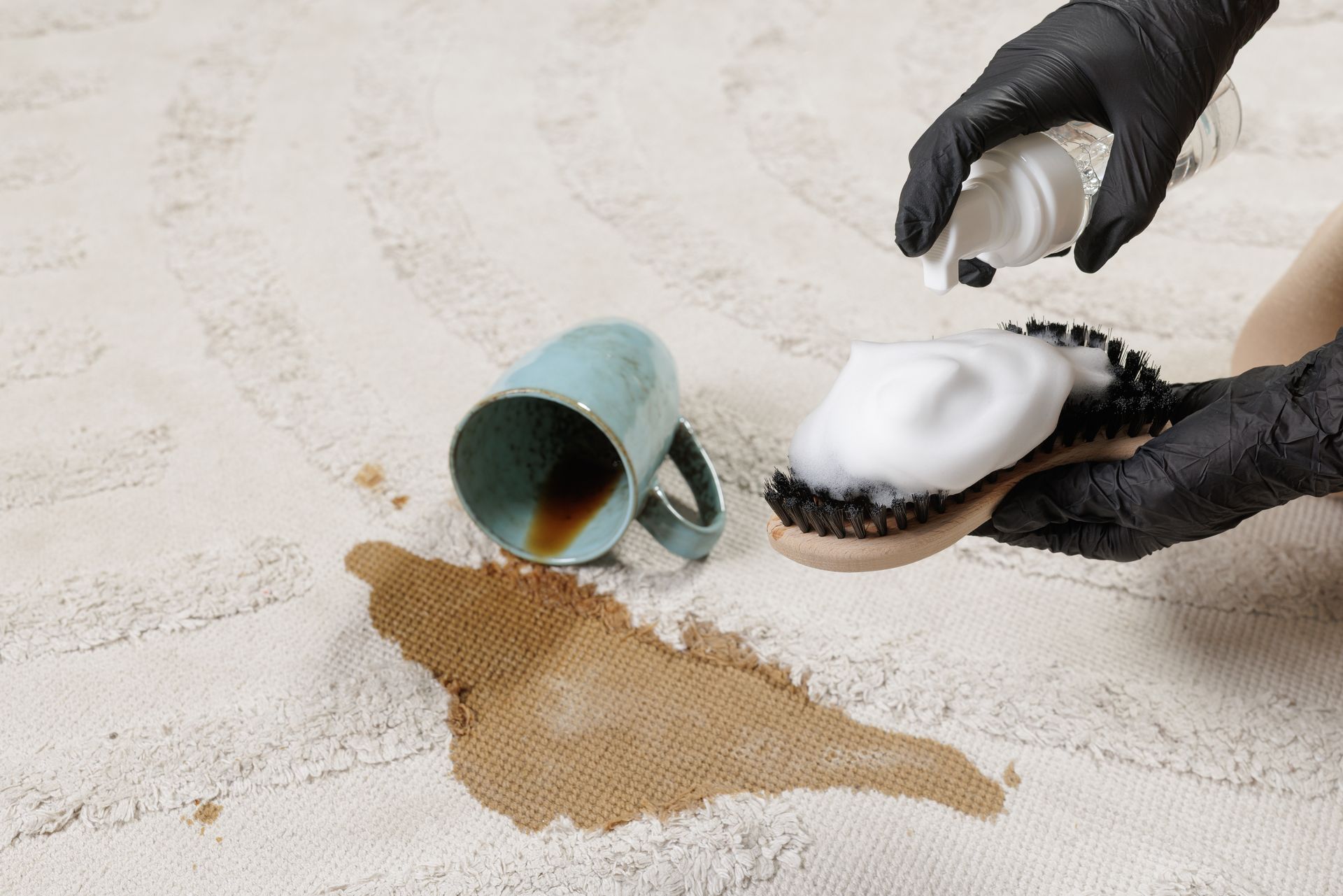 a professional removing spilled coffee stain from a carpet