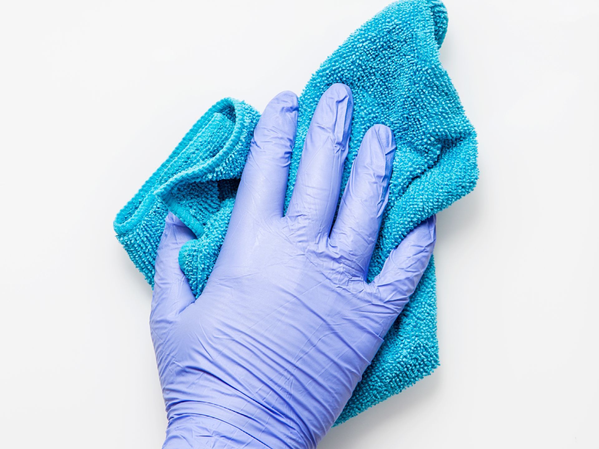 Blue gloved hand holding a turquoise microfiber cloth on a white background
