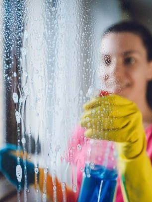 housekeeper cleaning window