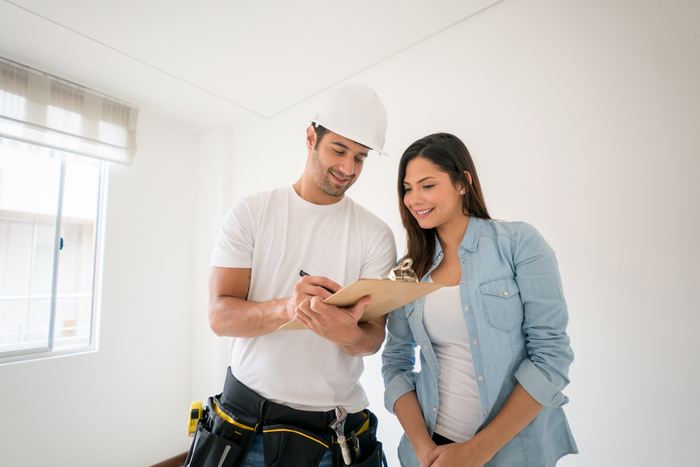 Bathroom remodeler giving a quote to a client