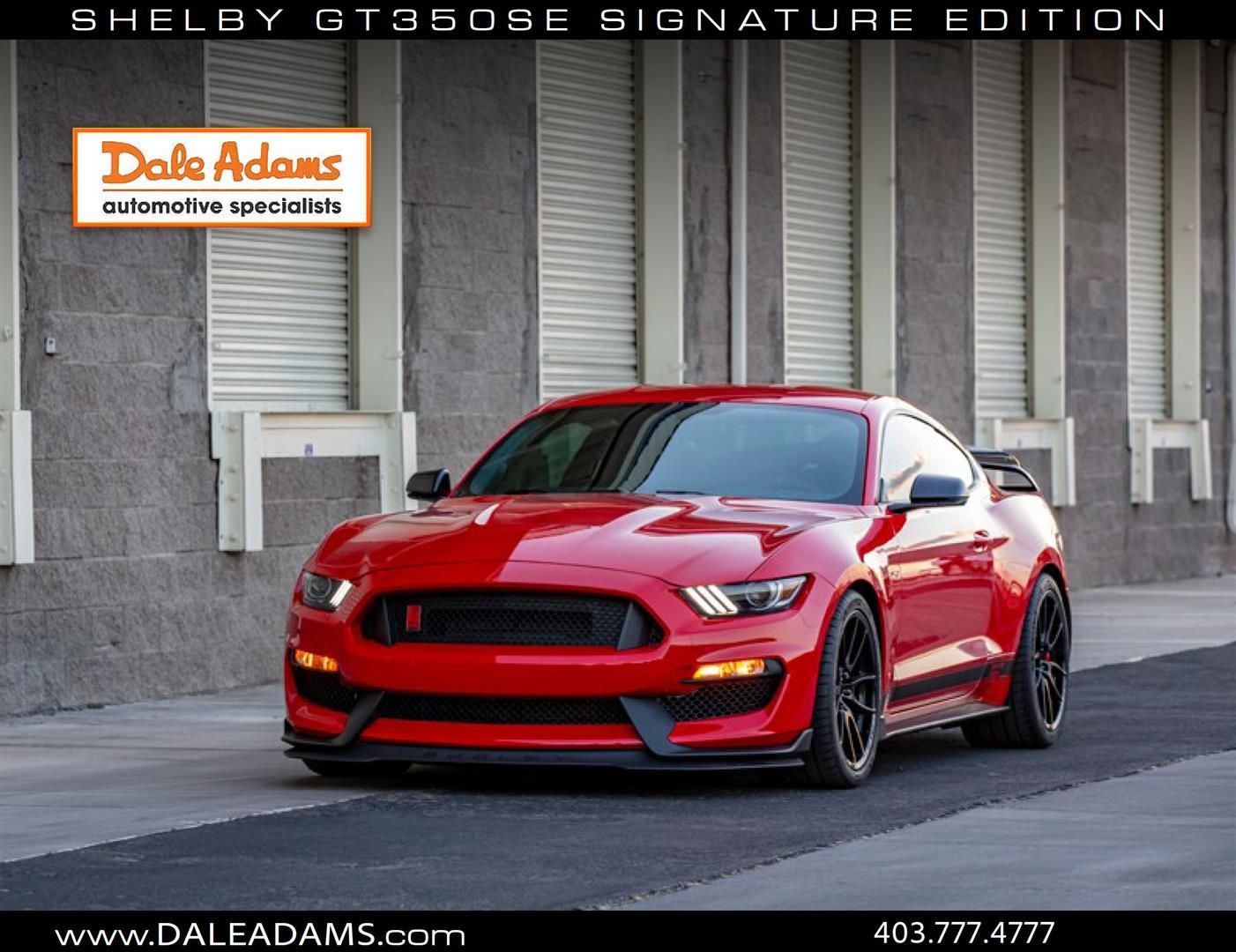 Red Shelby GT350SE Mustang parked in front of a building with Dale Adams logo and sign.