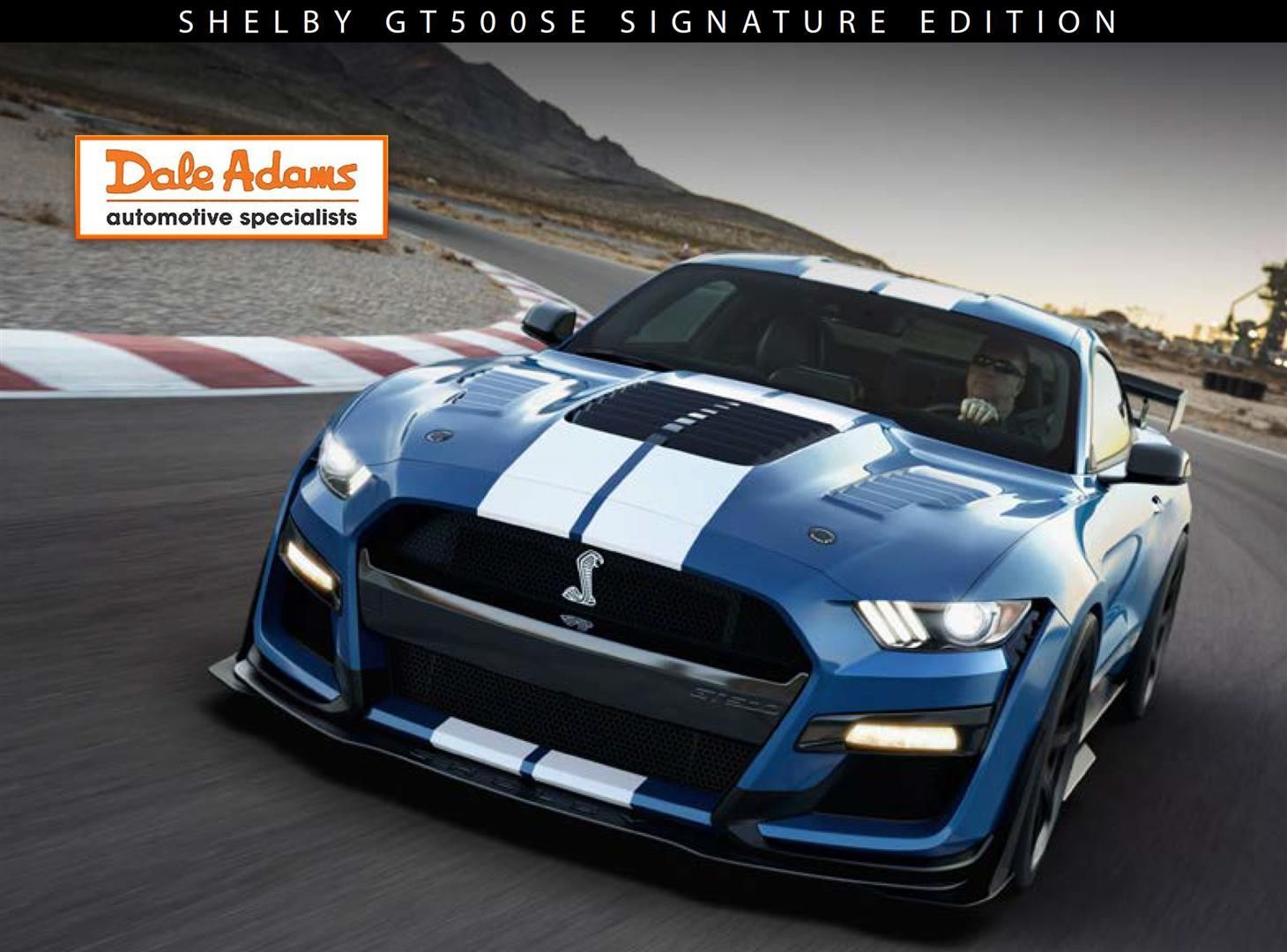 Blue Ford Shelby GT500 on a racetrack, with Shellby Gt500 Signature Edition text and Dalz Motors logo.
