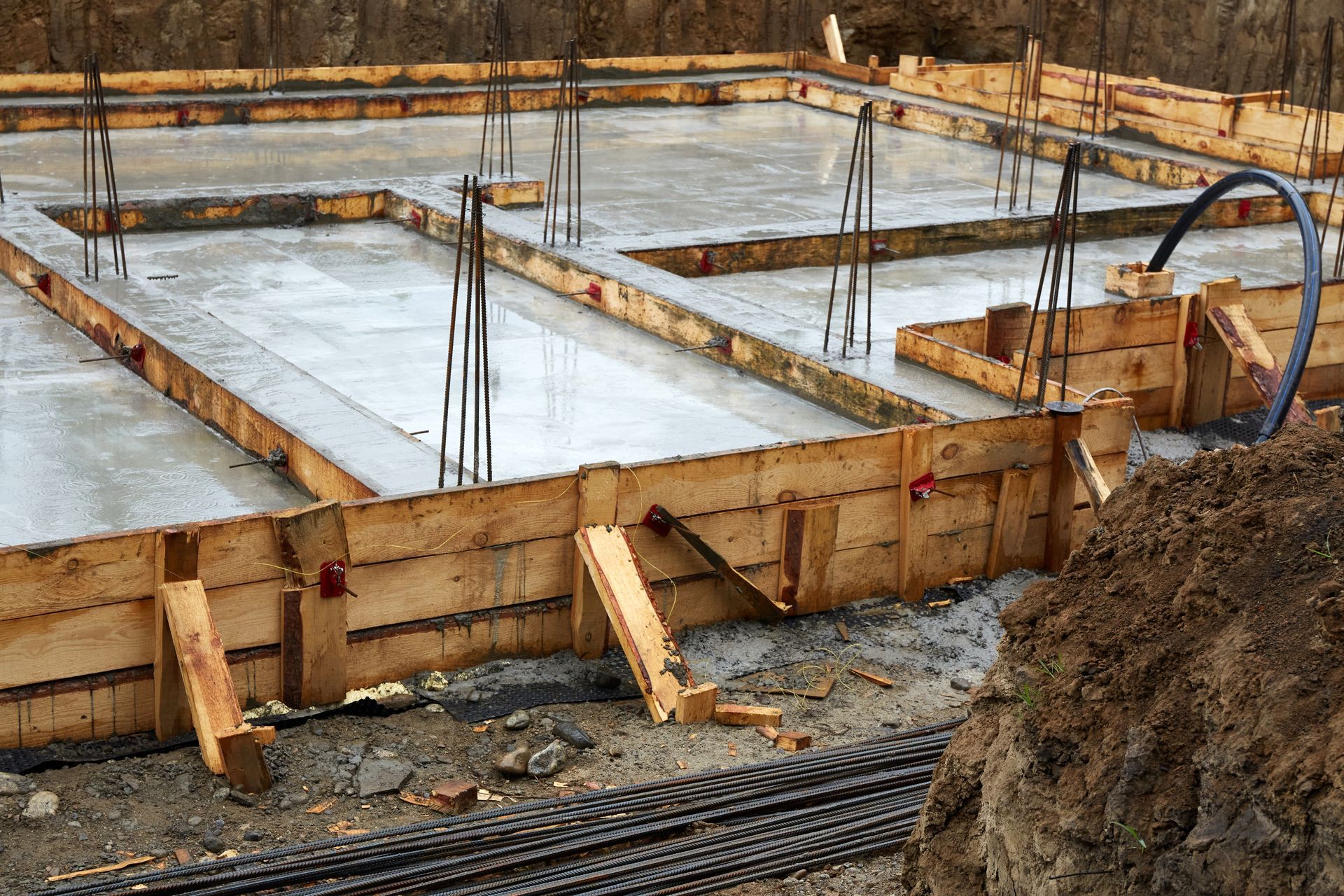 Concrete foundation under construction with wooden forms and rebar at a building site