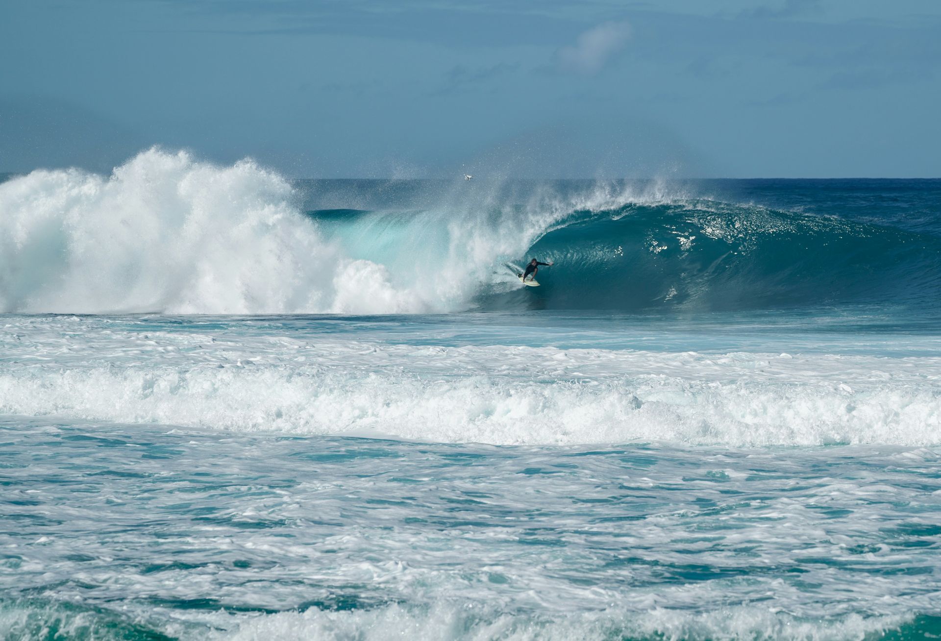 The North Shore of Oahu with turquoise water, surf, and golden sand