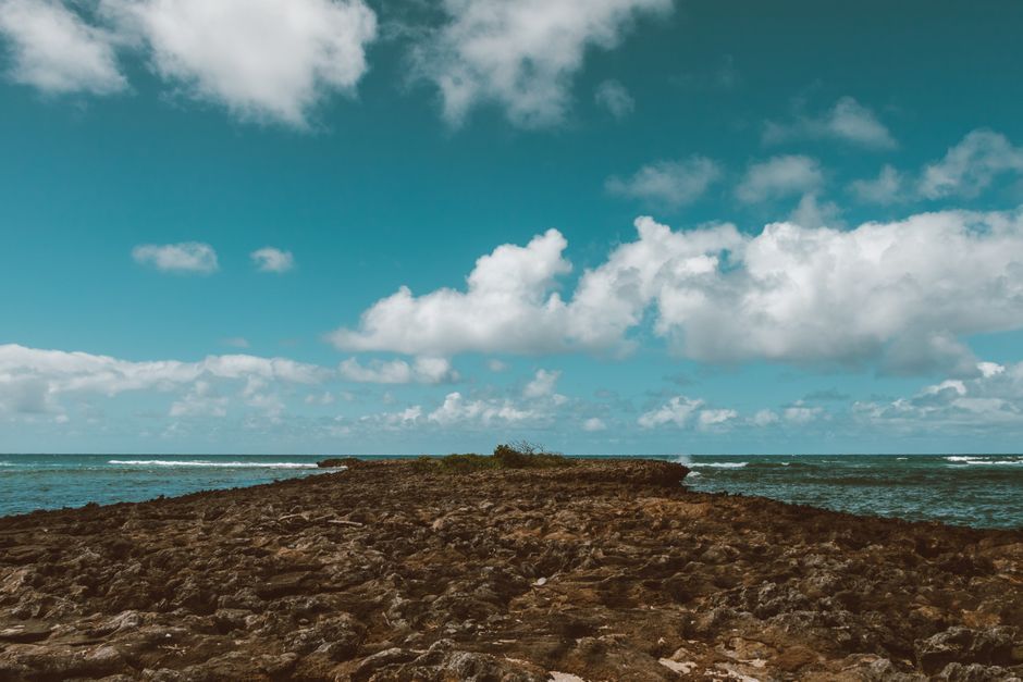 A rocky lava cove with clear turquoise water on the Oahu North Shore