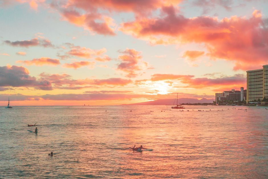 Waikiki Beach in Oahu at golden hour with Diamond Head in the distance