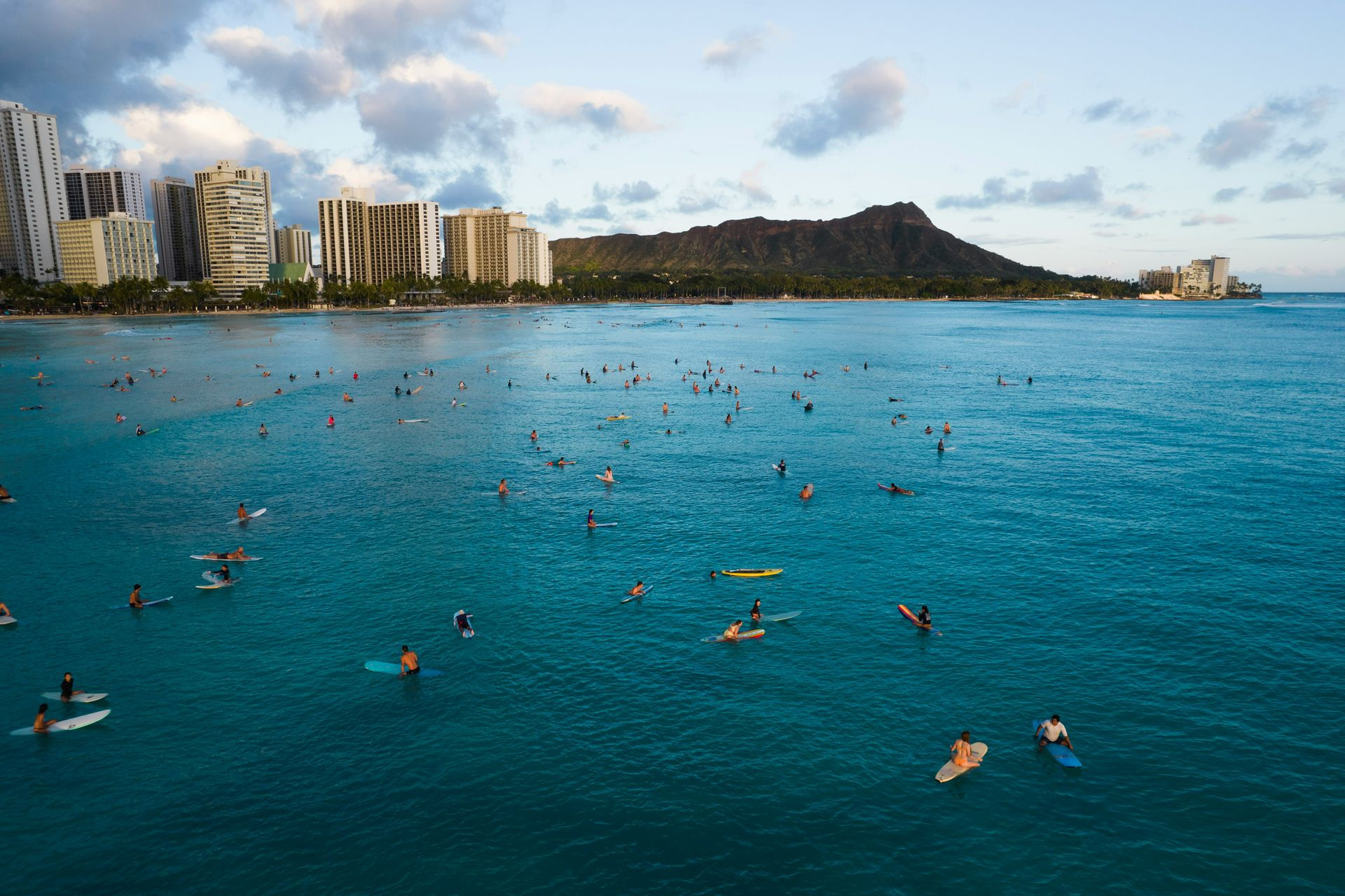 Aerial image of surfers at Waikiki beach with Diamond head in the background