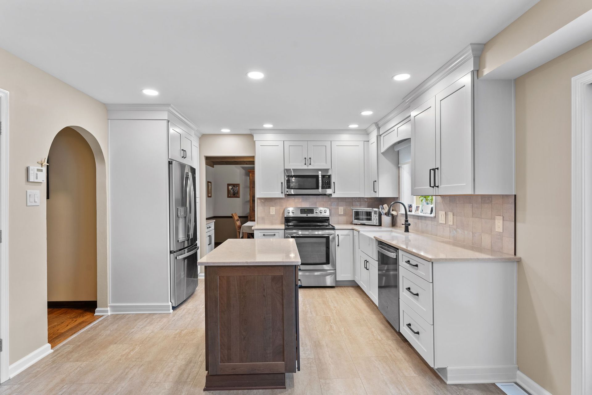 Bright modern kitchen with white cabinets, stainless appliances, and a central island  In Bucks County PA