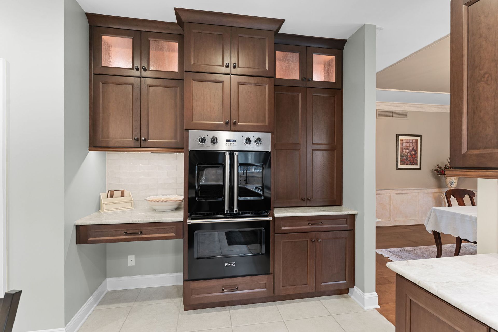 Modern kitchen with dark wood cabinets and built-in stainless steel ovens In Bucks Country PA