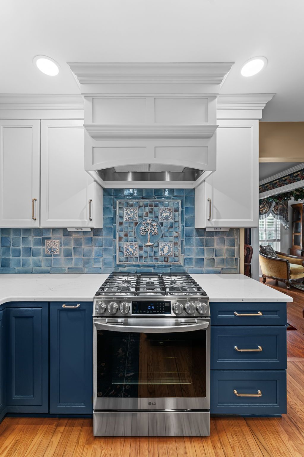 Blue and white kitchen with stainless steel range, hood, and mosaic tile backsplash  In Bucks County PA