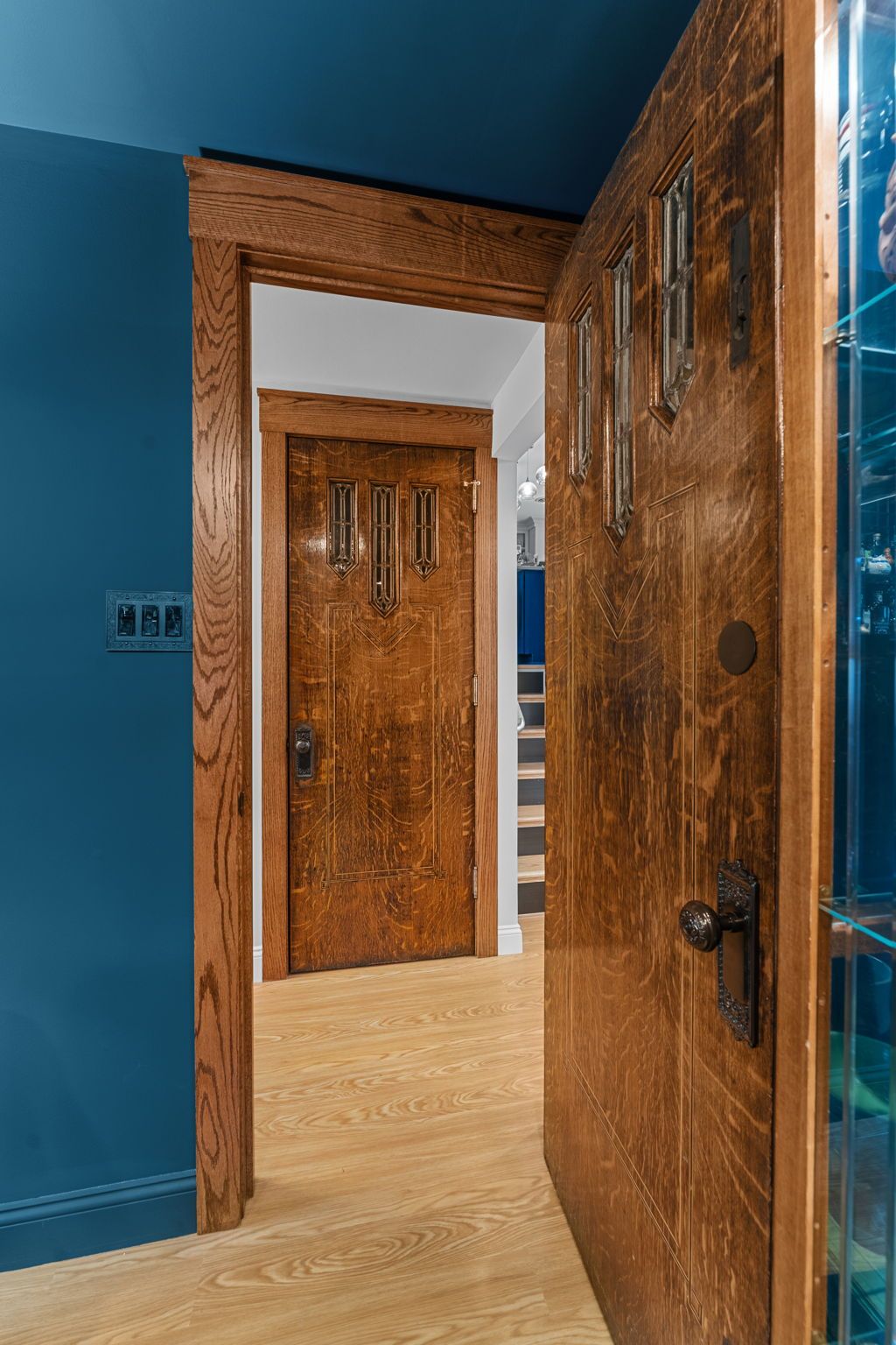 Open wooden doors in a blue-painted hallway, showing a second door beyond In Bucks County PA