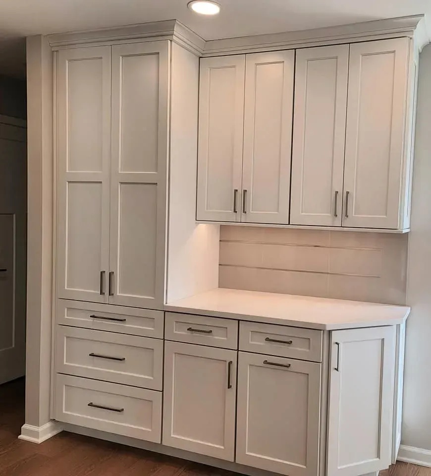 Built-in white cabinets with drawers, doors, and upper storage in a home interior  In Bucks County PA