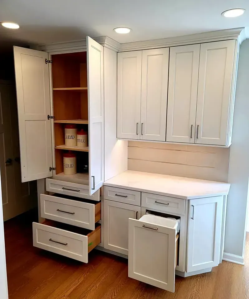 Custom white kitchen cabinetry with open and closed drawers and a pull-out pantry  In Bucks County PA