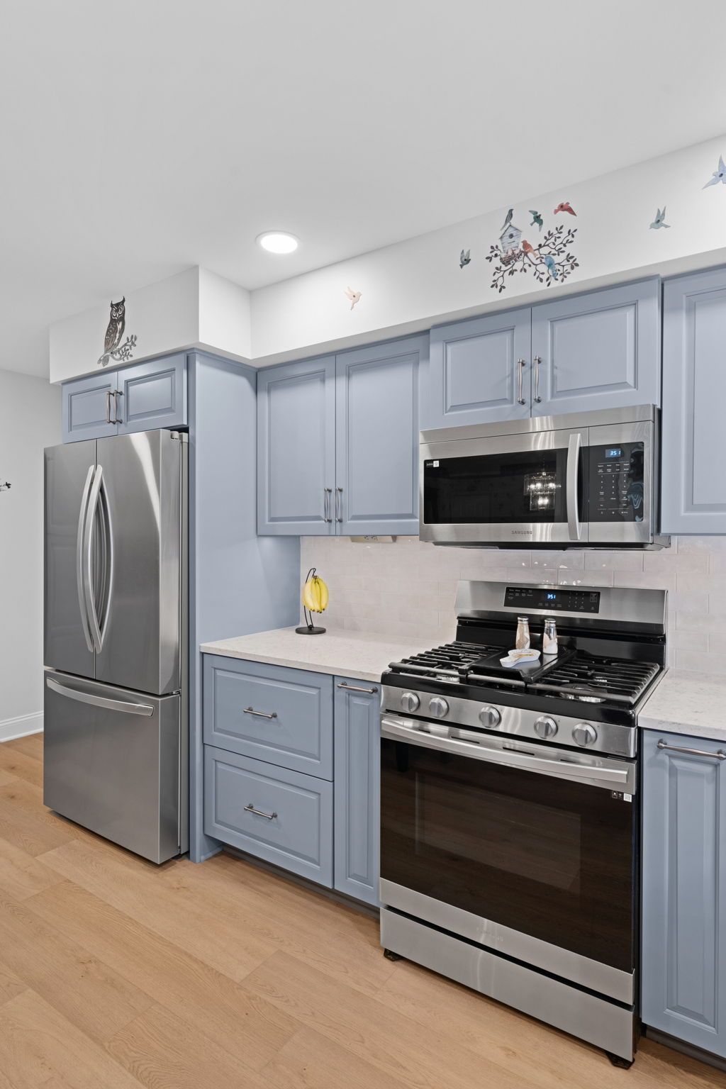 Modern kitchen with stainless steel appliances and light blue cabinets In Bucks County PA