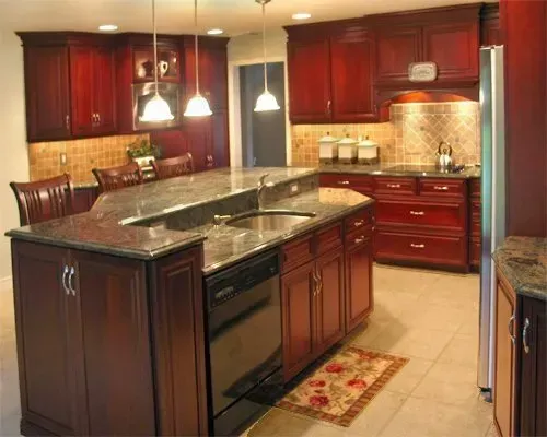 Modern kitchen with dark wood cabinets, granite island, pendant lights, and beige tile flooring In Bucks Country PA
