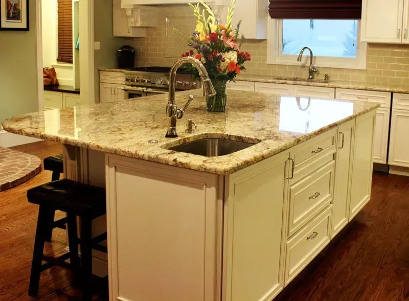 Kitchen with granite island, sink, flower vase, and stainless steel appliances In Bucks County PA