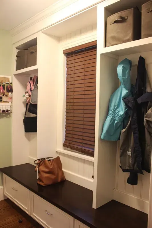 Built-in hallway bench with cubbies, coats, bags, and window blinds In Bucks County PA