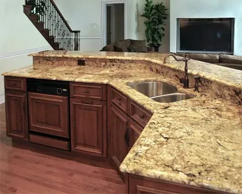 Granite kitchen island with built-in sink and dishwasher in a modern home interior In Bucks County PA
