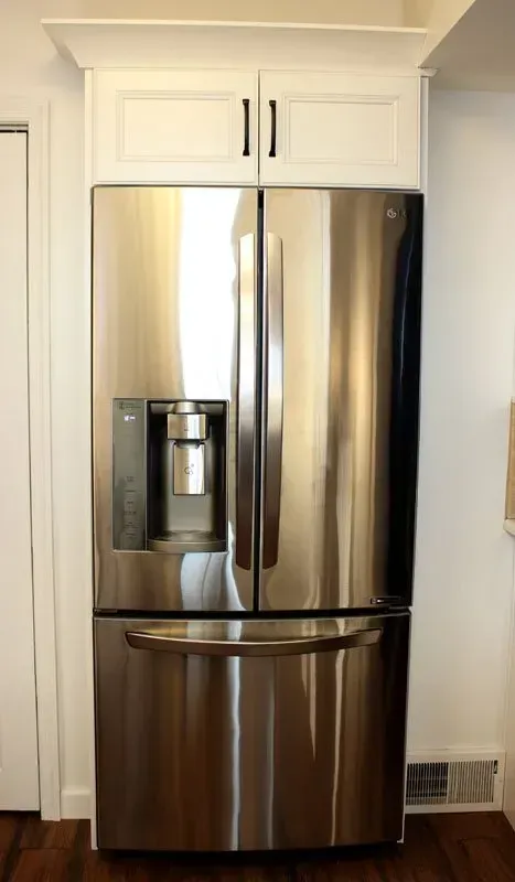 Stainless steel French door refrigerator with bottom freezer in a white kitchen alcove In Bucks County PA