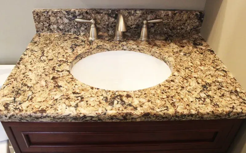 Speckled granite bathroom vanity with round white sink and chrome faucet  In Bucks County PA