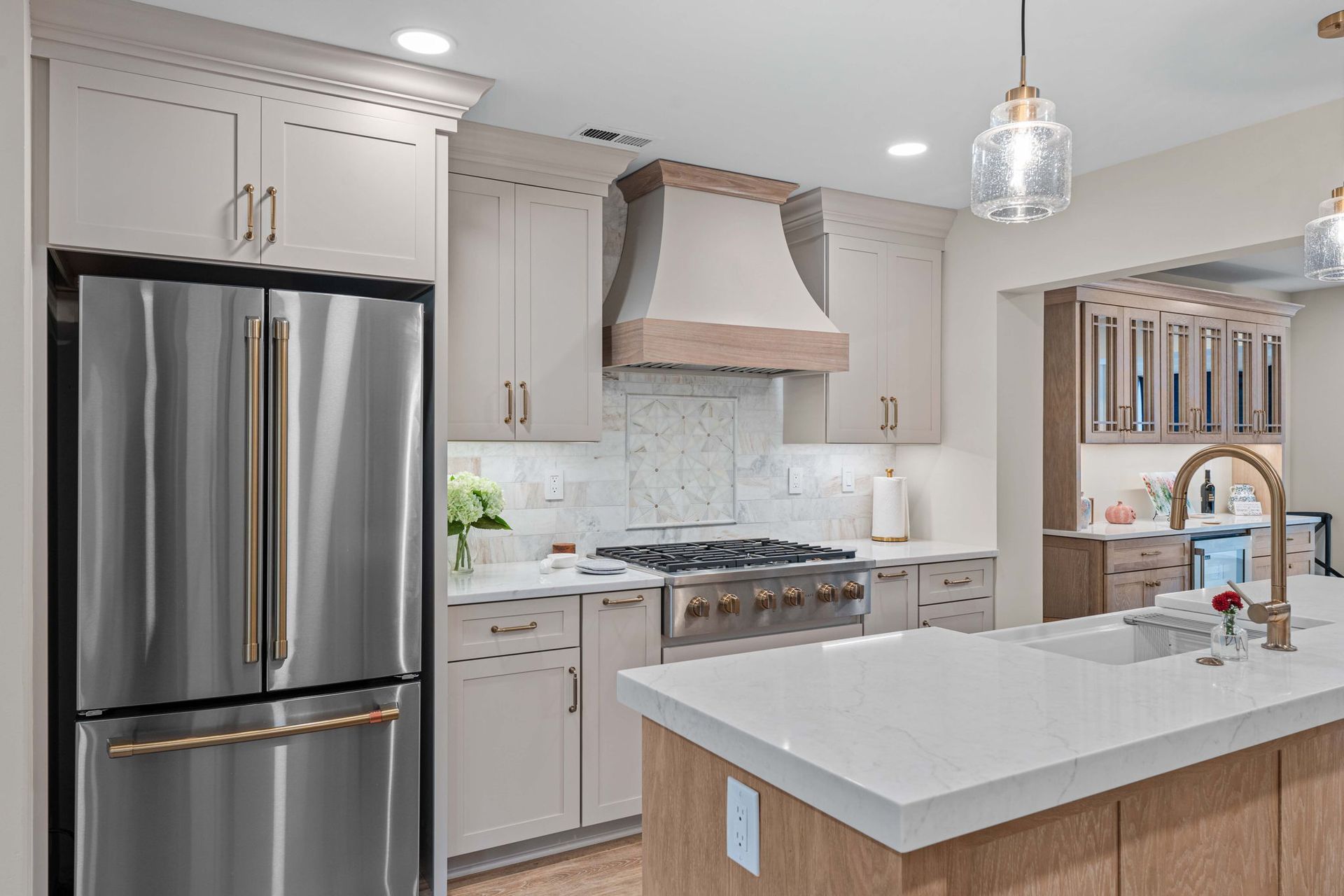 Modern kitchen with stainless steel appliances, white cabinets, and a large island sink in Bucks County PA