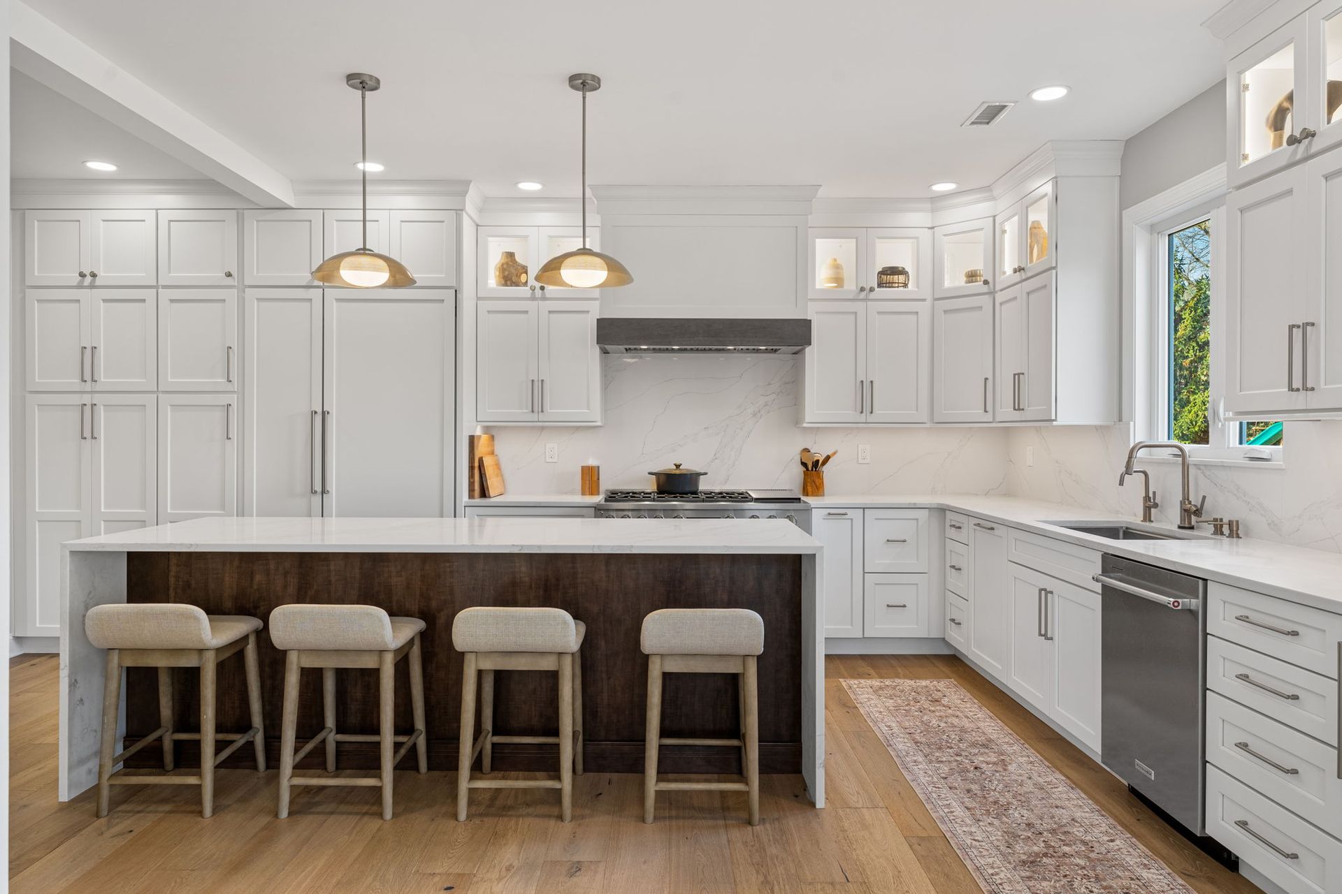 Bright white modern kitchen with island, pendant lights, and four stools In Bucks Country PA