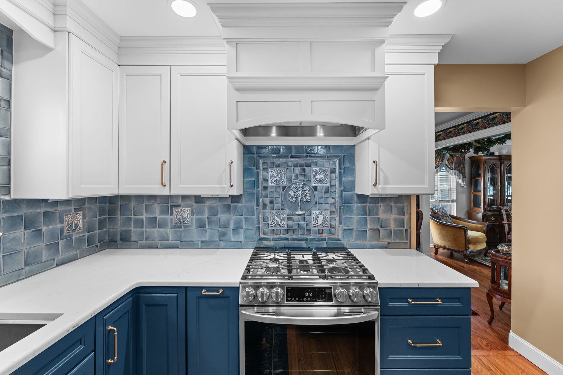 White and blue kitchen with tiled backsplash, stainless stove, and navy lower cabinets  In Bucks County PA