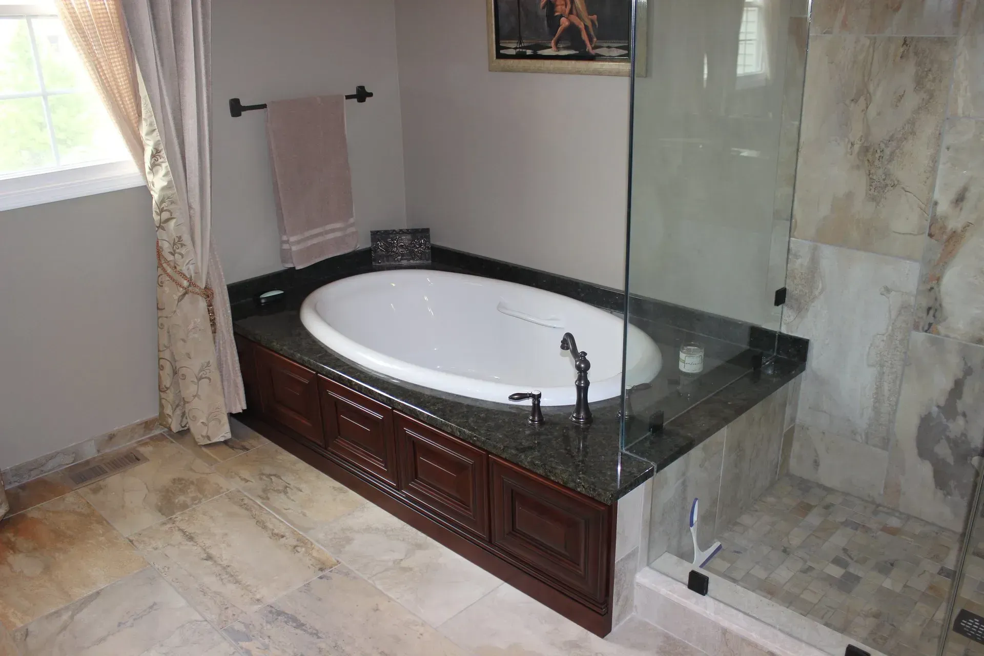 Luxury bathroom with a corner soaking tub, glass shower, and marble tile flooring  In Bucks County PA