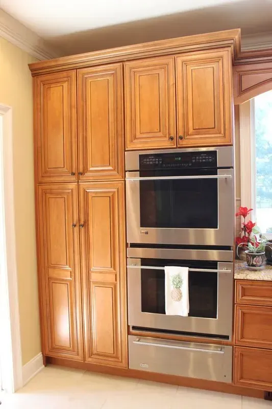 Built-in stainless steel double oven in light wood kitchen cabinets  In Bucks County PA