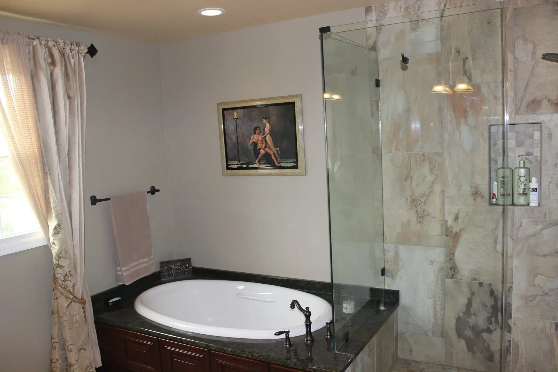 Luxury bathroom with jetted tub, marble shower, and a framed picture on the wall In Bucks County PA
