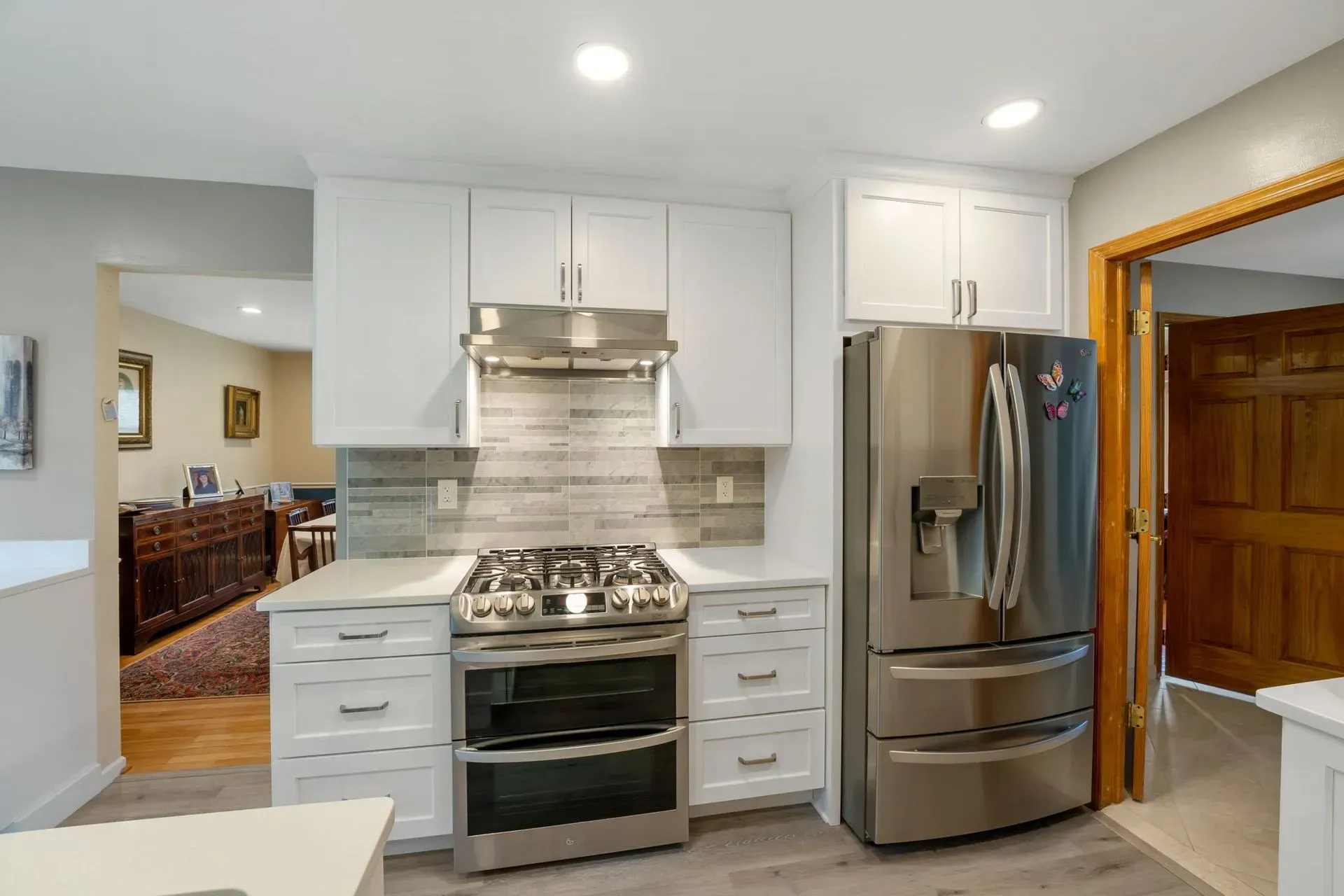 Modern kitchen with white cabinets, stainless steel appliances, and a large refrigerator in Bucks County PA