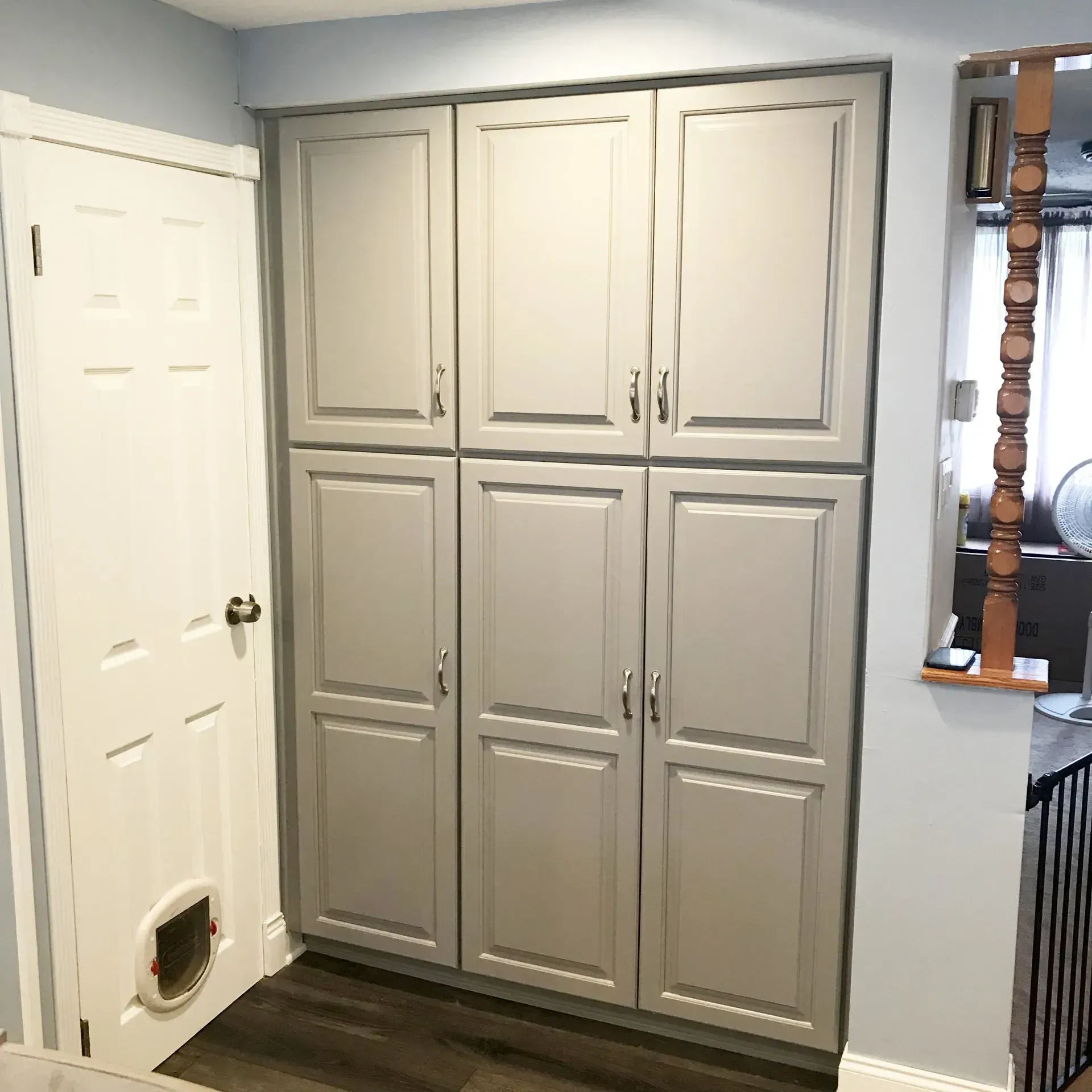 Built-in beige cabinets beside a white door in a home interior  In Bucks County PA