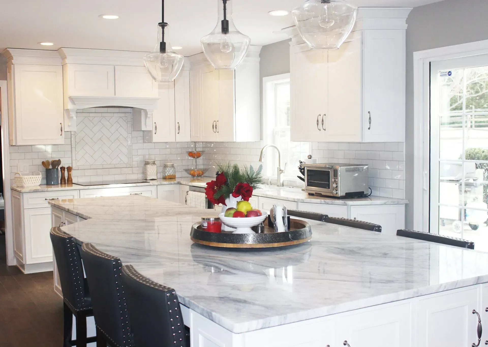 Bright white kitchen with marble island, pendant lights, and fruit centerpiece  In Bucks County PA