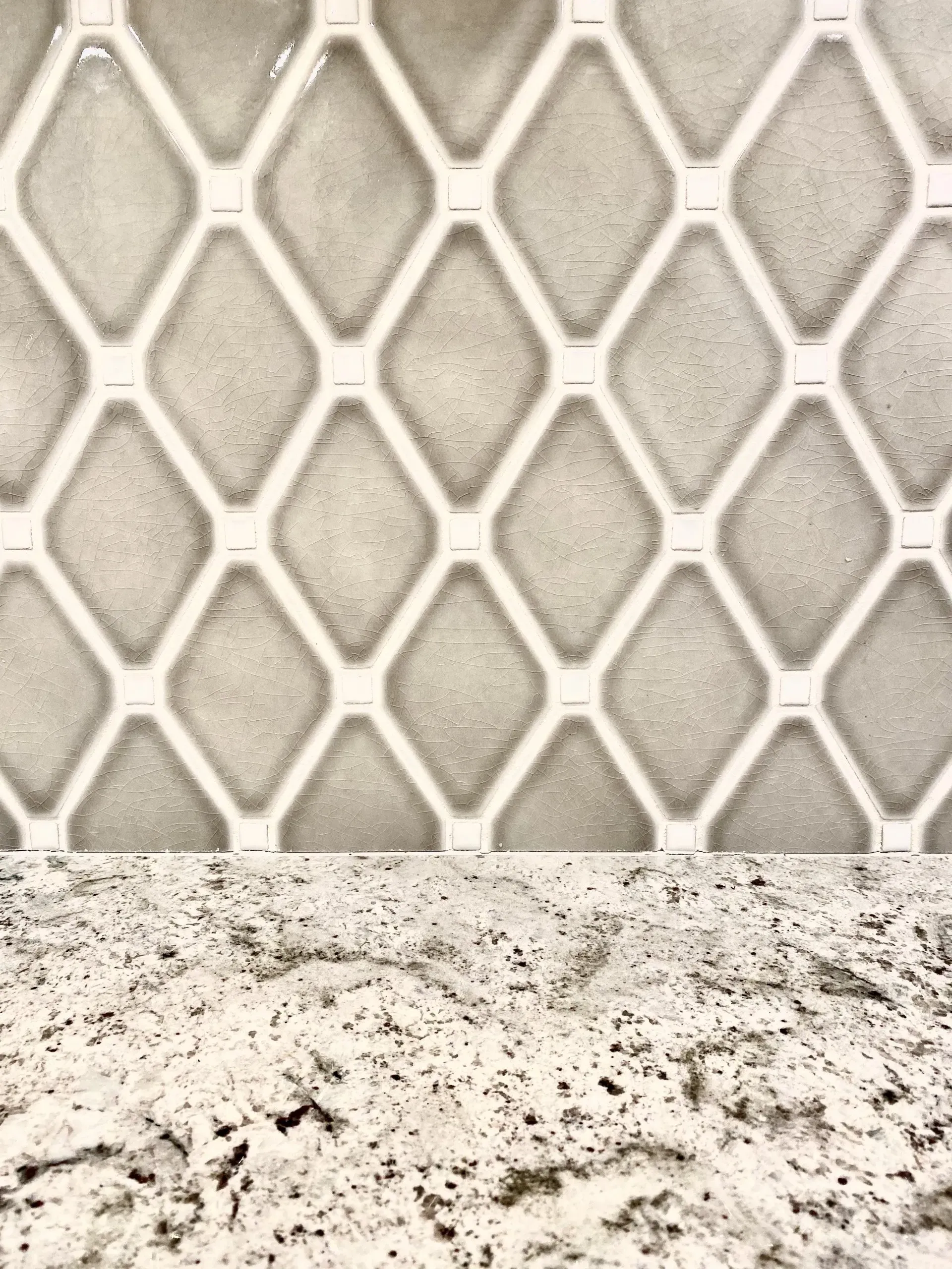 Close-up of a white diamond-pattern mesh above a speckled stone surface In Bucks County PA