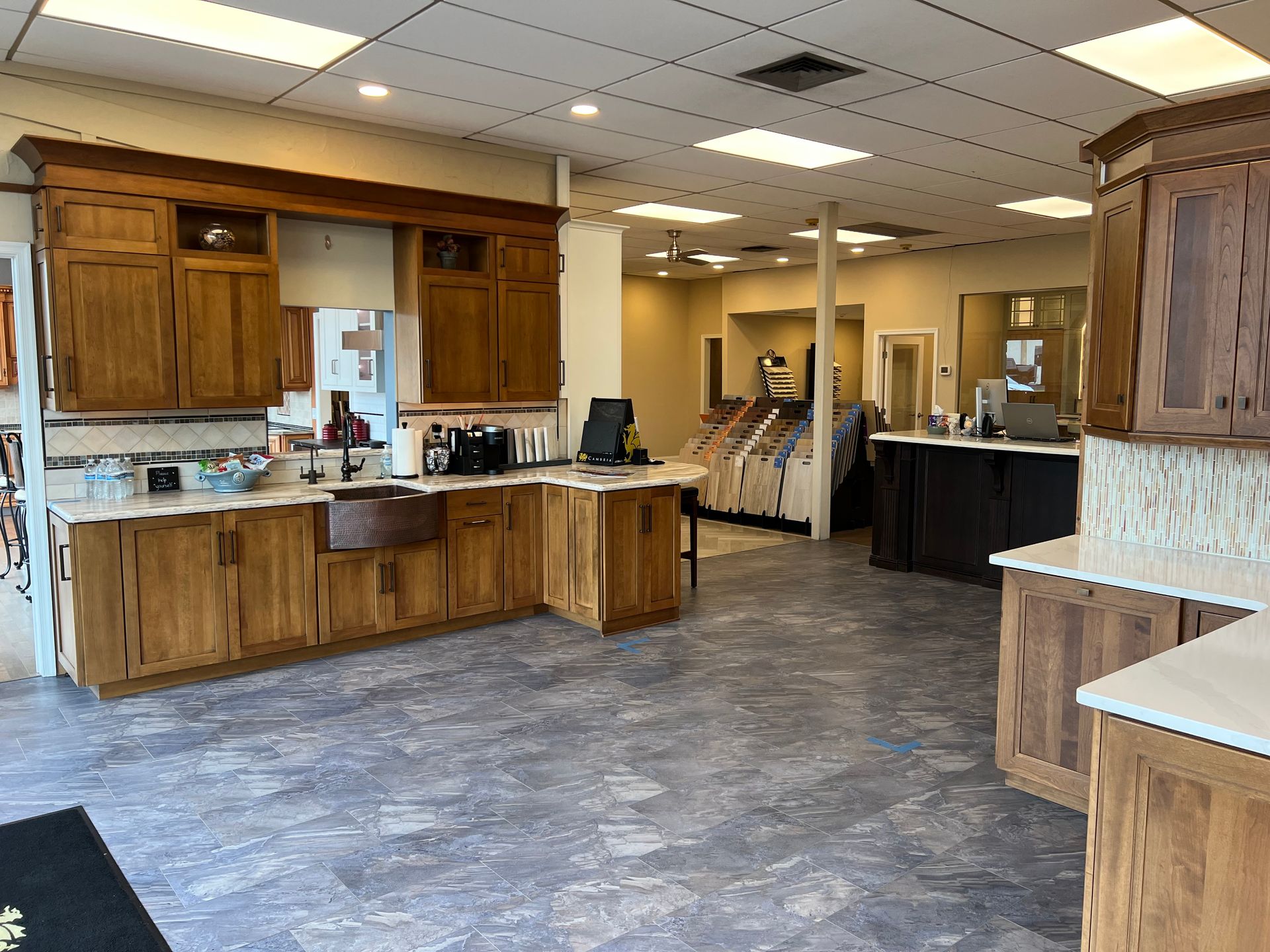 Modern kitchen showroom with island, bar stools, and display cabinets In Bucks Country PA