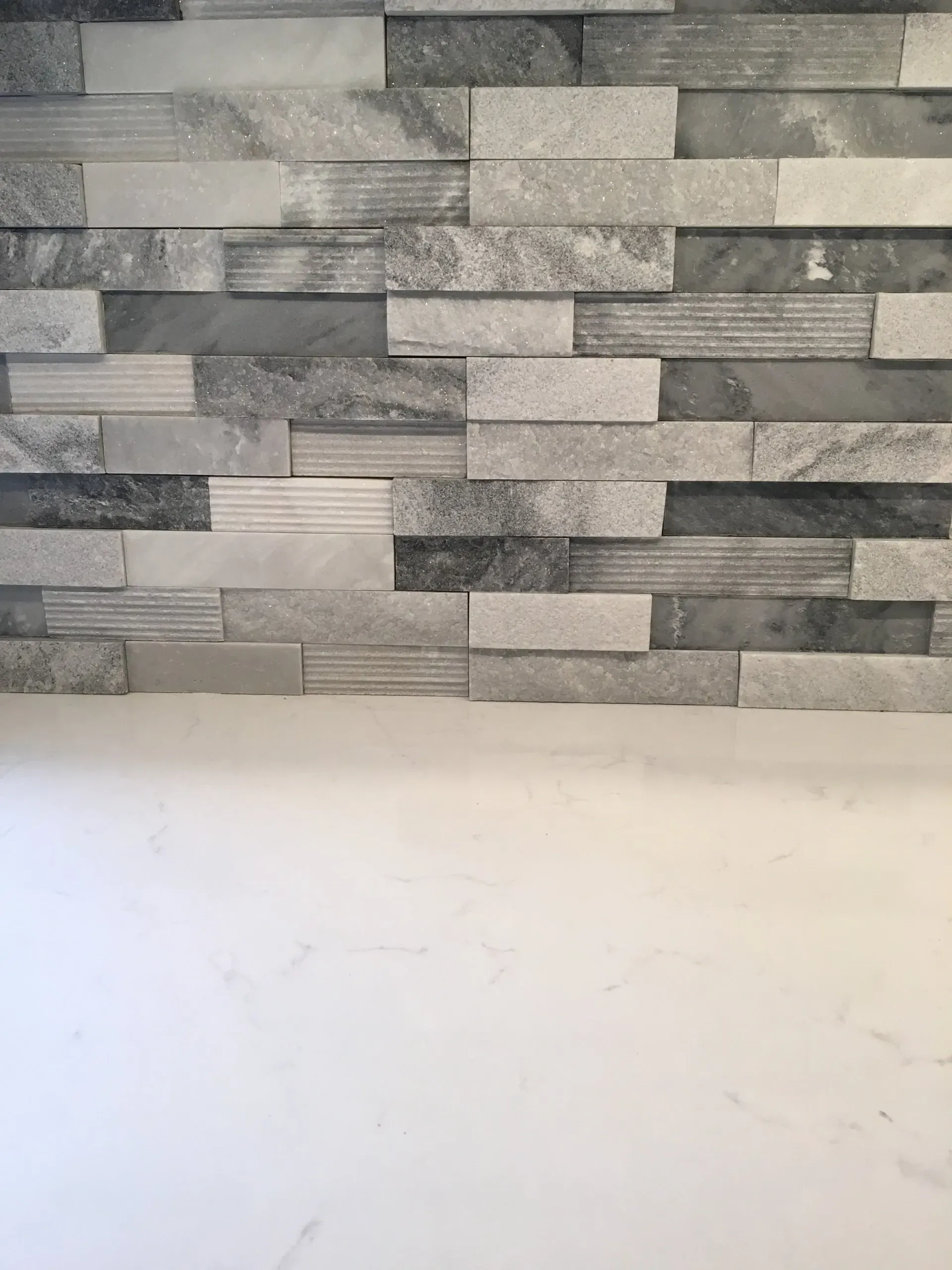 Gray stone tile backsplash above a white countertop or wall  In Bucks County PA