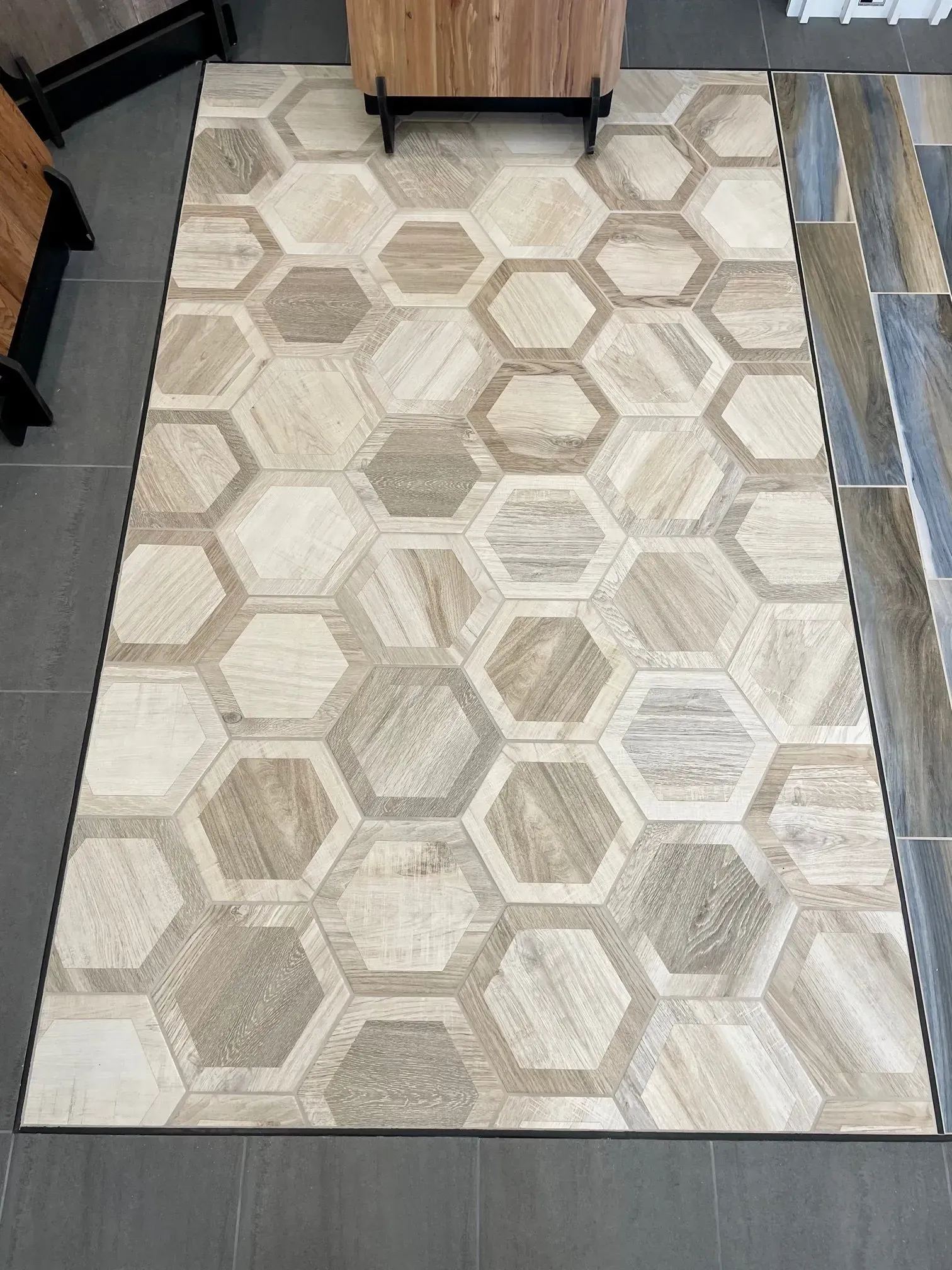 Beige hexagon-pattern area rug on a gray floor between furniture pieces  In Bucks County PA