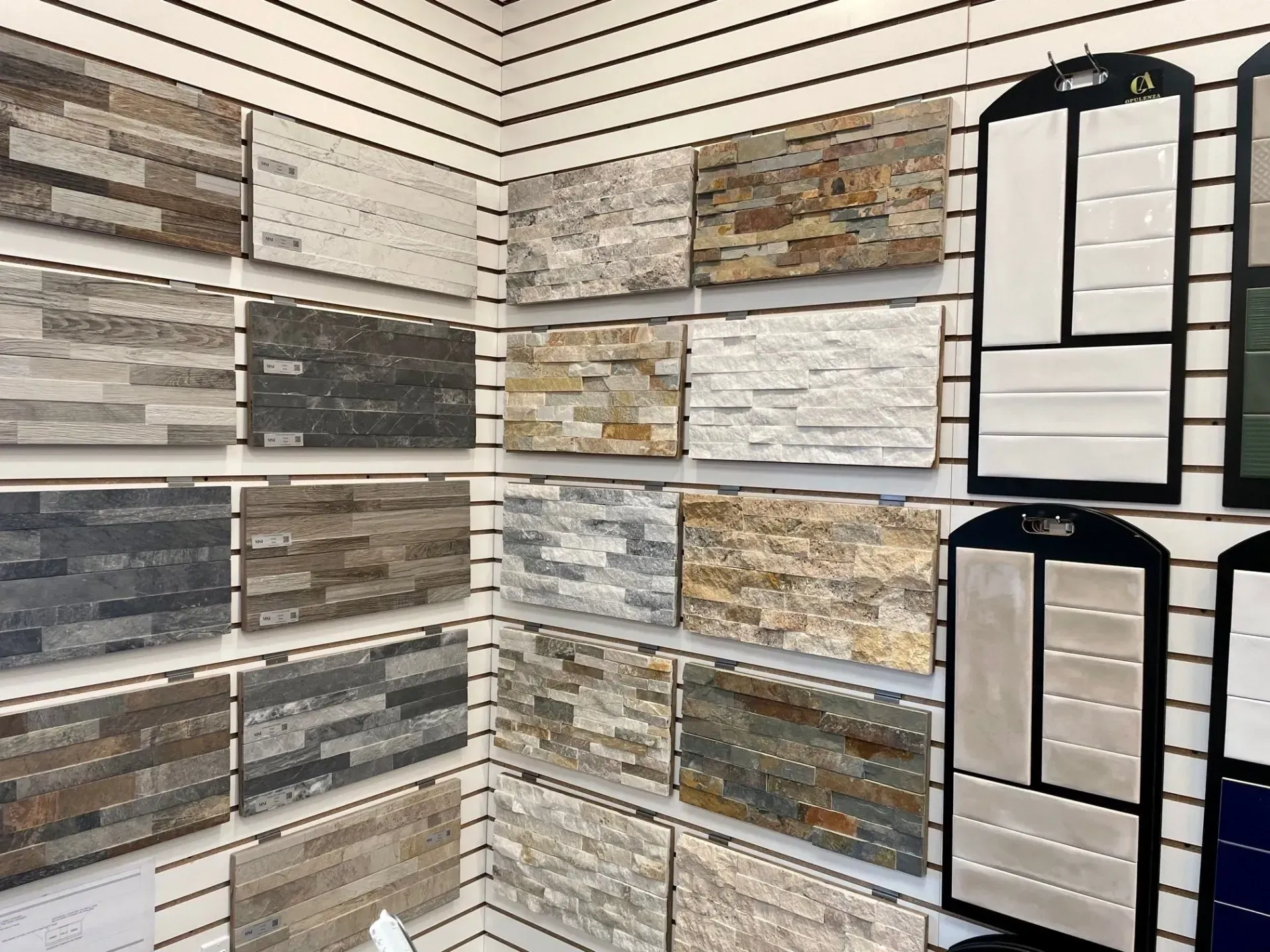 Tile showroom corner with stacked stone wall samples in gray, tan, and white tones  In Bucks County PA