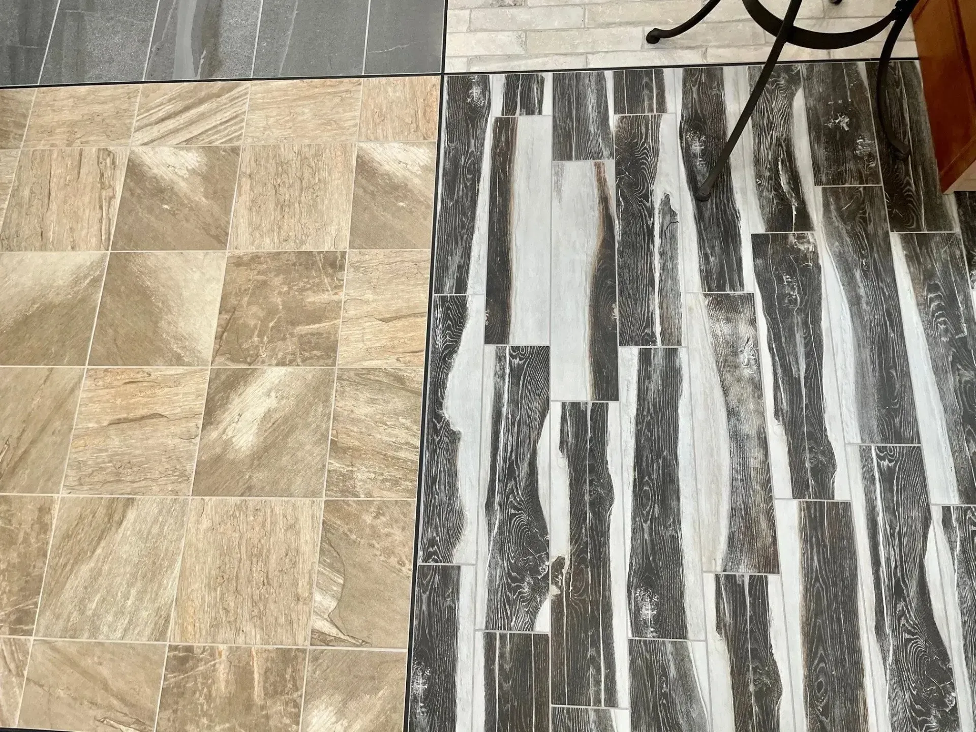 Beige and gray patterned floor tiles side by side, showing two different stone finishes  In Bucks County PA