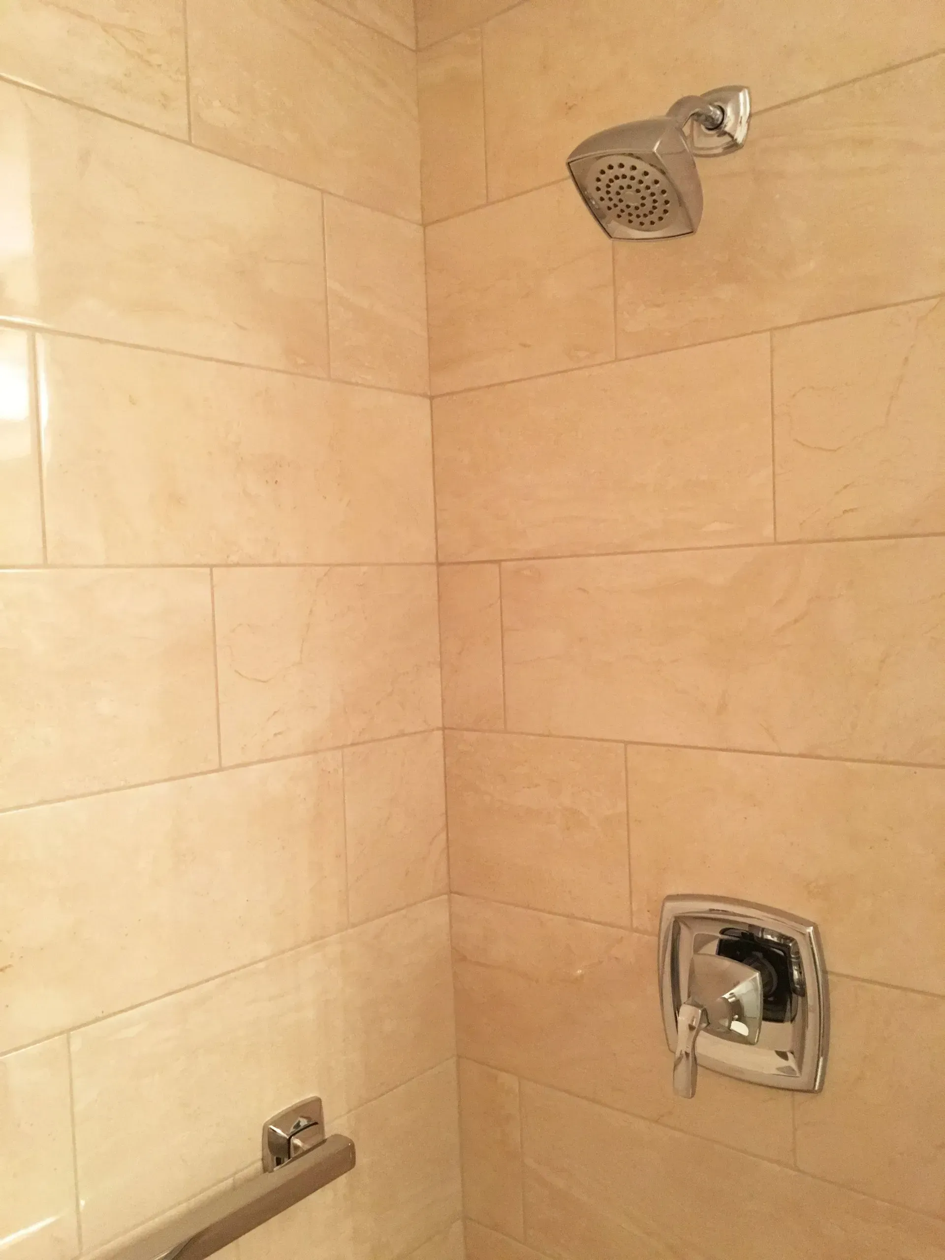 Tiled shower corner with wall-mounted showerhead and faucet fixtures  In Bucks County PA