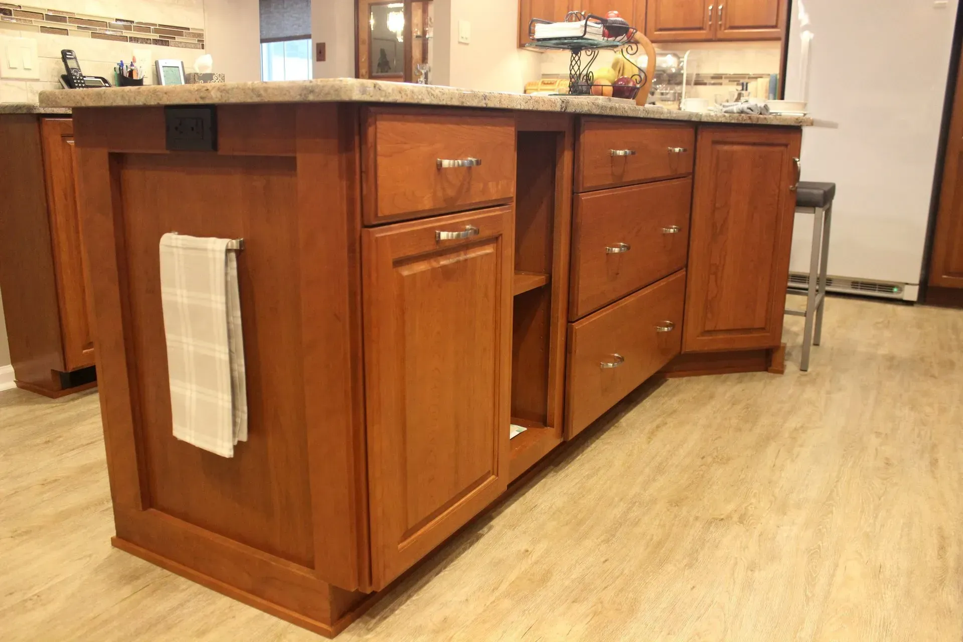 Wooden kitchen island with drawers and towel rack on a light wood floor in a home kitchen In Bucks County PA