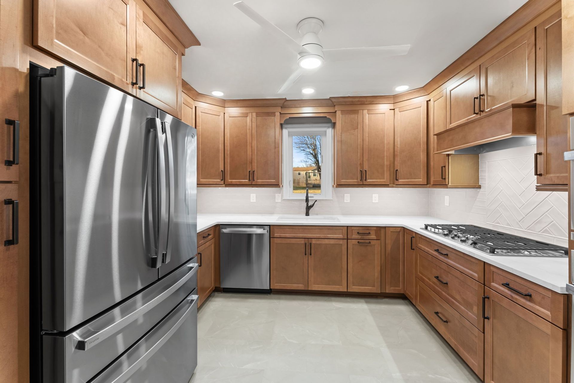 Bright kitchen with stainless steel appliances, wood cabinets, and white countertops  In Bucks County PA