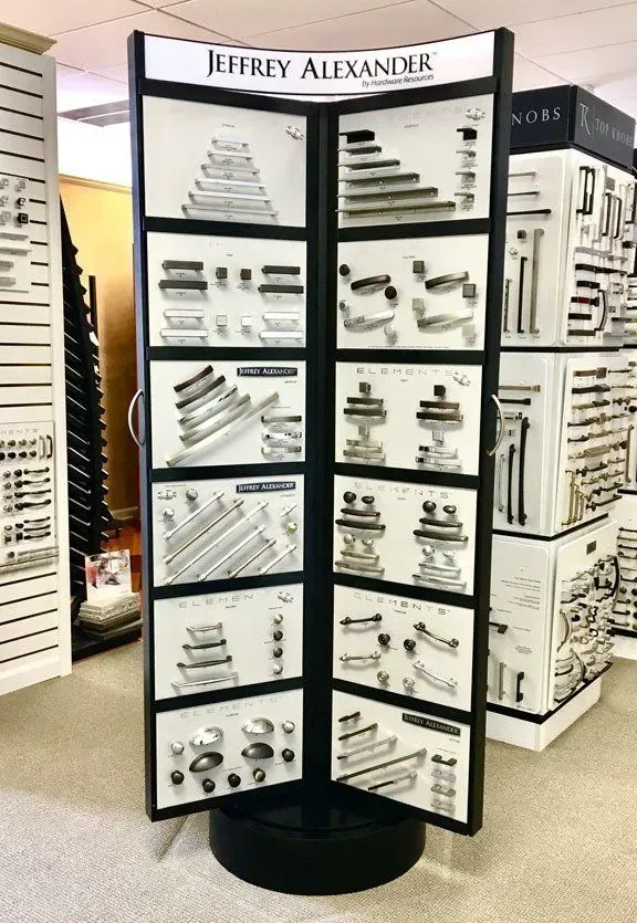 Display of Jeffery Alexander cabinet hardware on a black rotating stand in a showroom In Bucks County PA