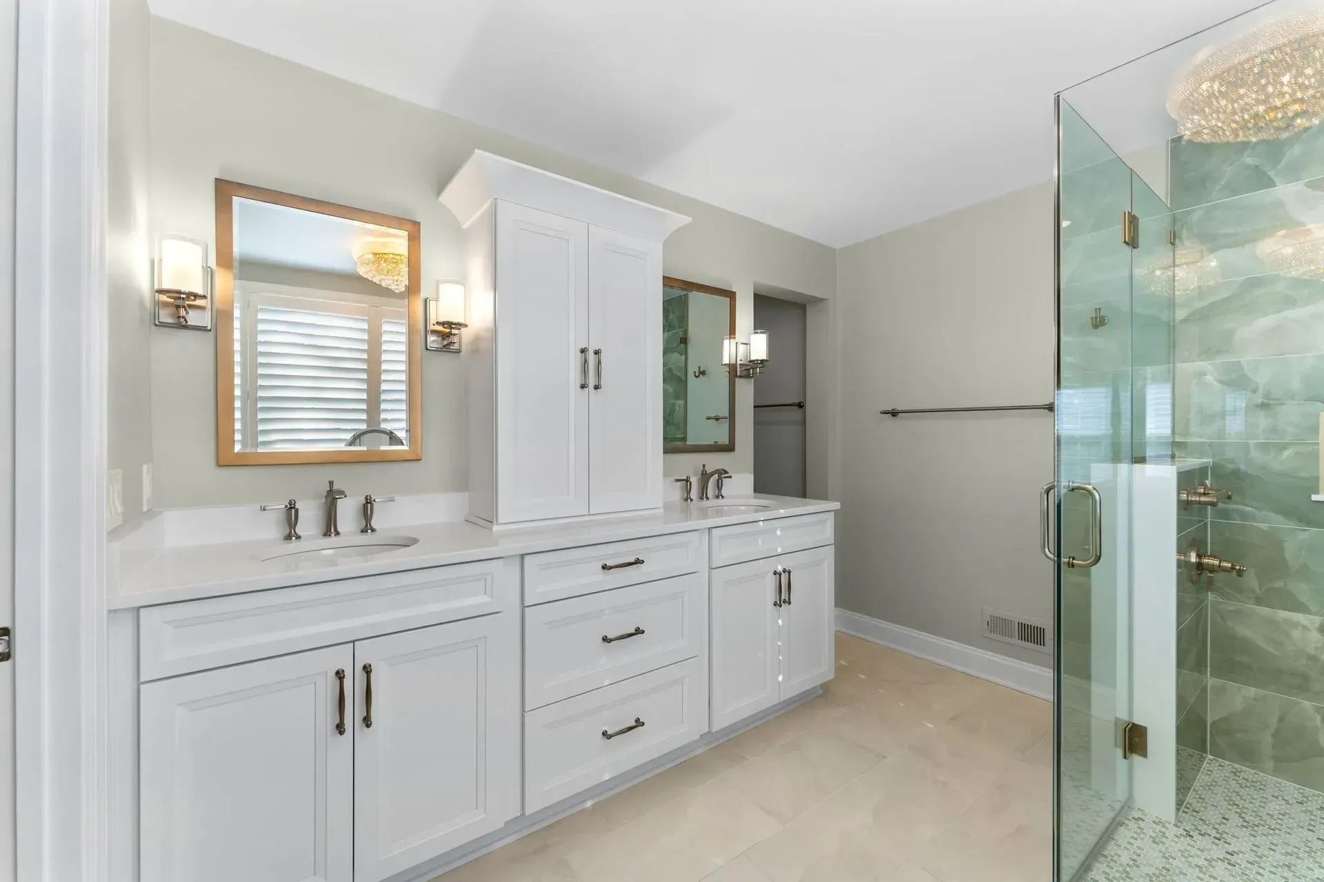 Modern white bathroom with double vanity, large mirror, and glass-enclosed shower In Bucks County PA