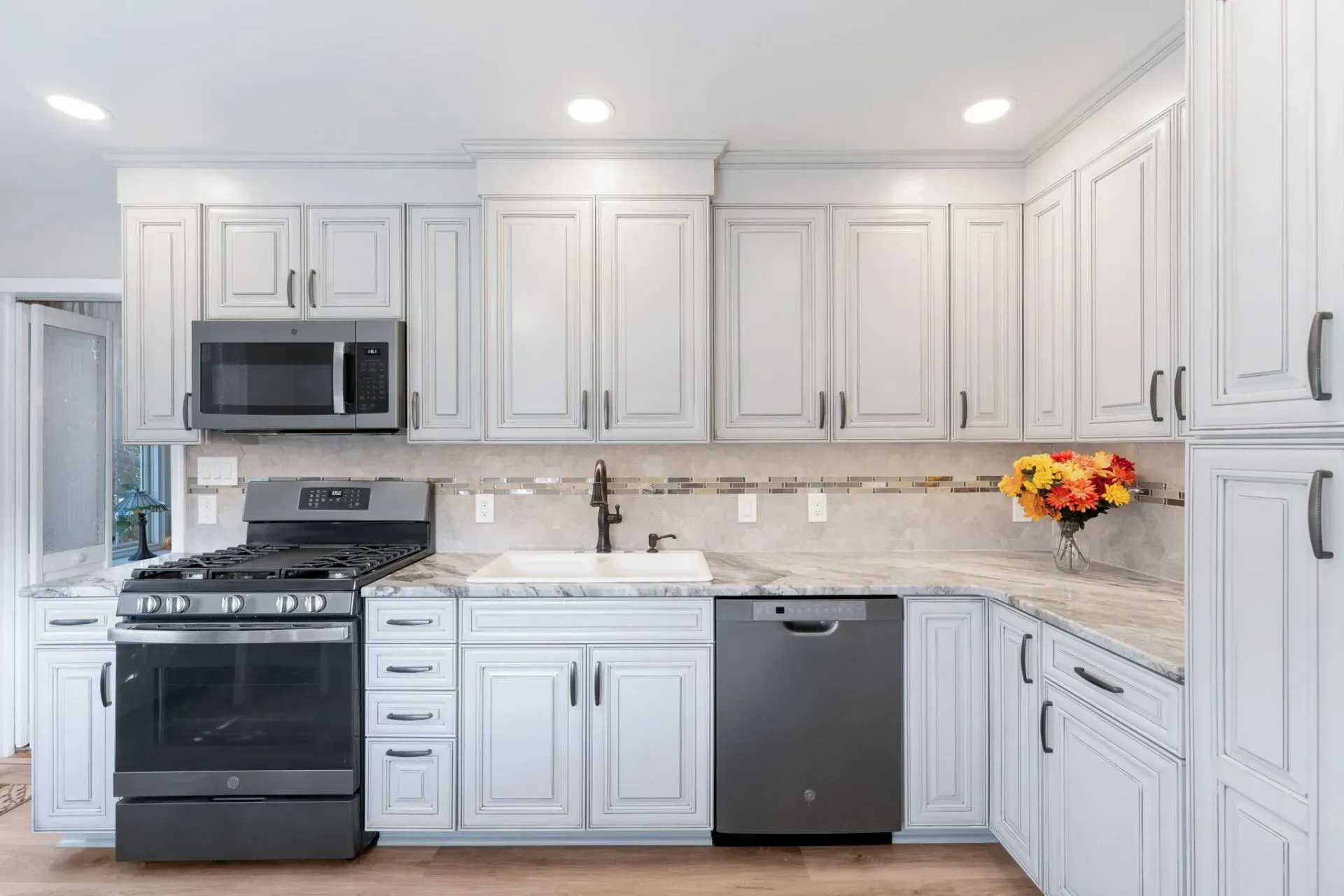 Bright white modern kitchen with stainless steel appliances and light countertops In Bucks Country PA