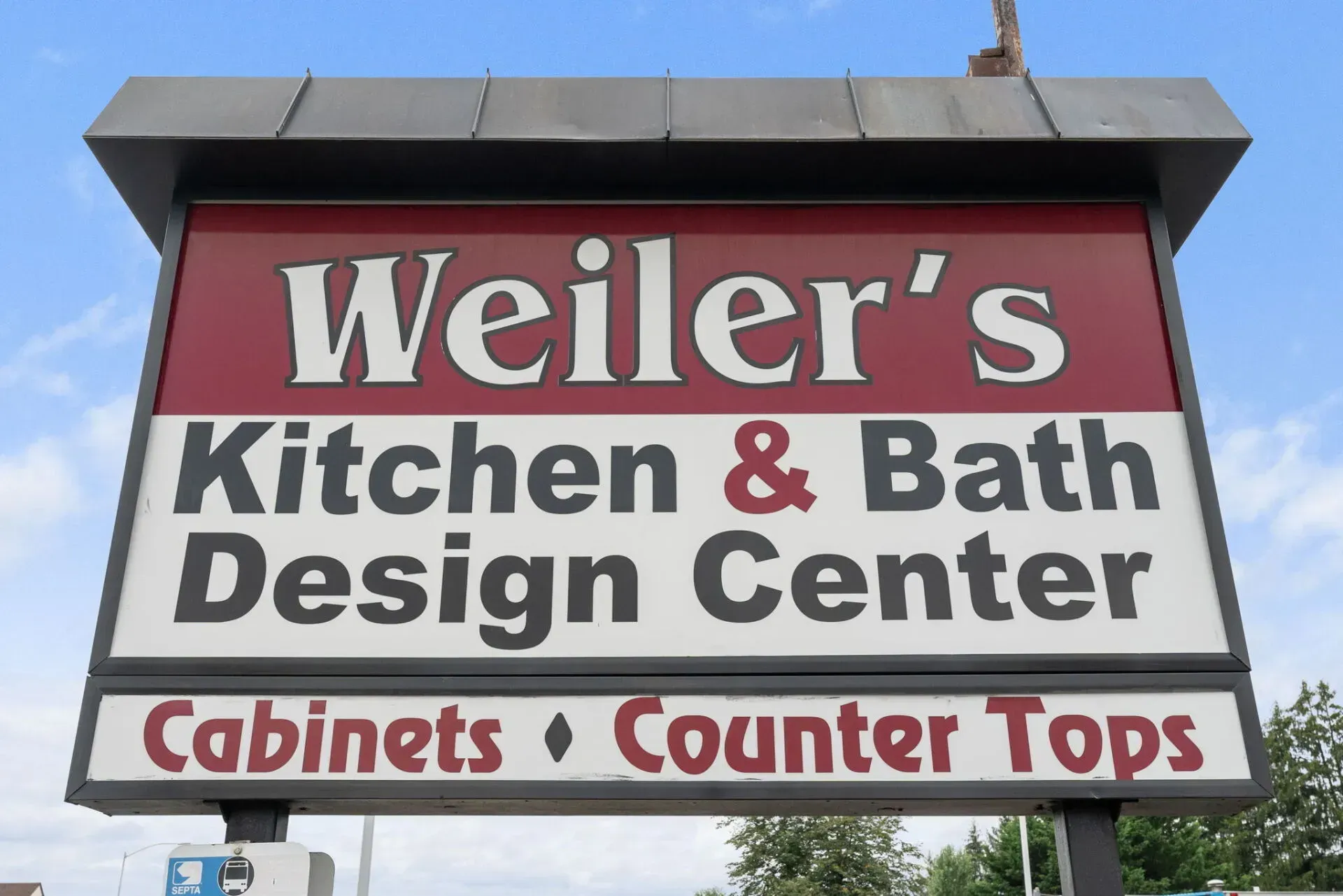Weiler’s Kitchen & Bath Design Center sign with red and white lettering, listing cabinets and counter tops  In Bucks County PA