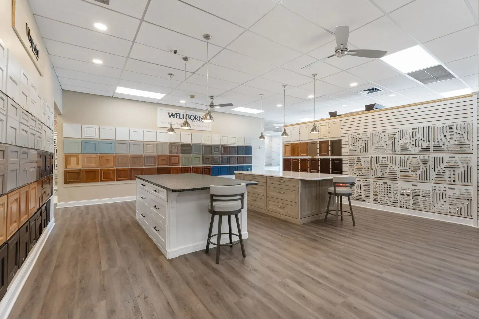 Modern showroom interior with sample display walls, white counters, and a stool on wood-look flooring  In Bucks County PA
