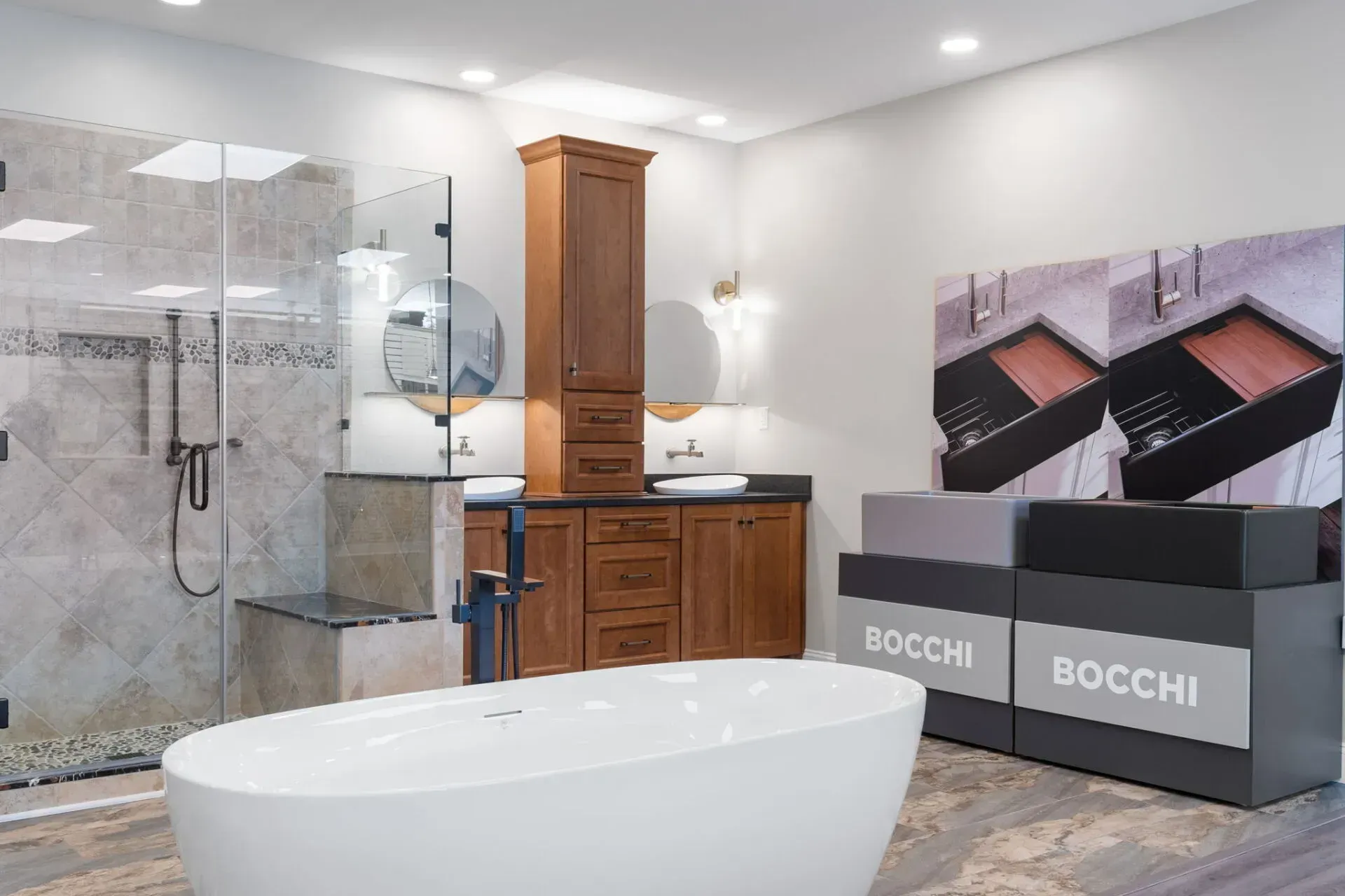 Modern bathroom with glass shower, freestanding tub, wood vanity, and a Bocchi product display  In Bucks County PA