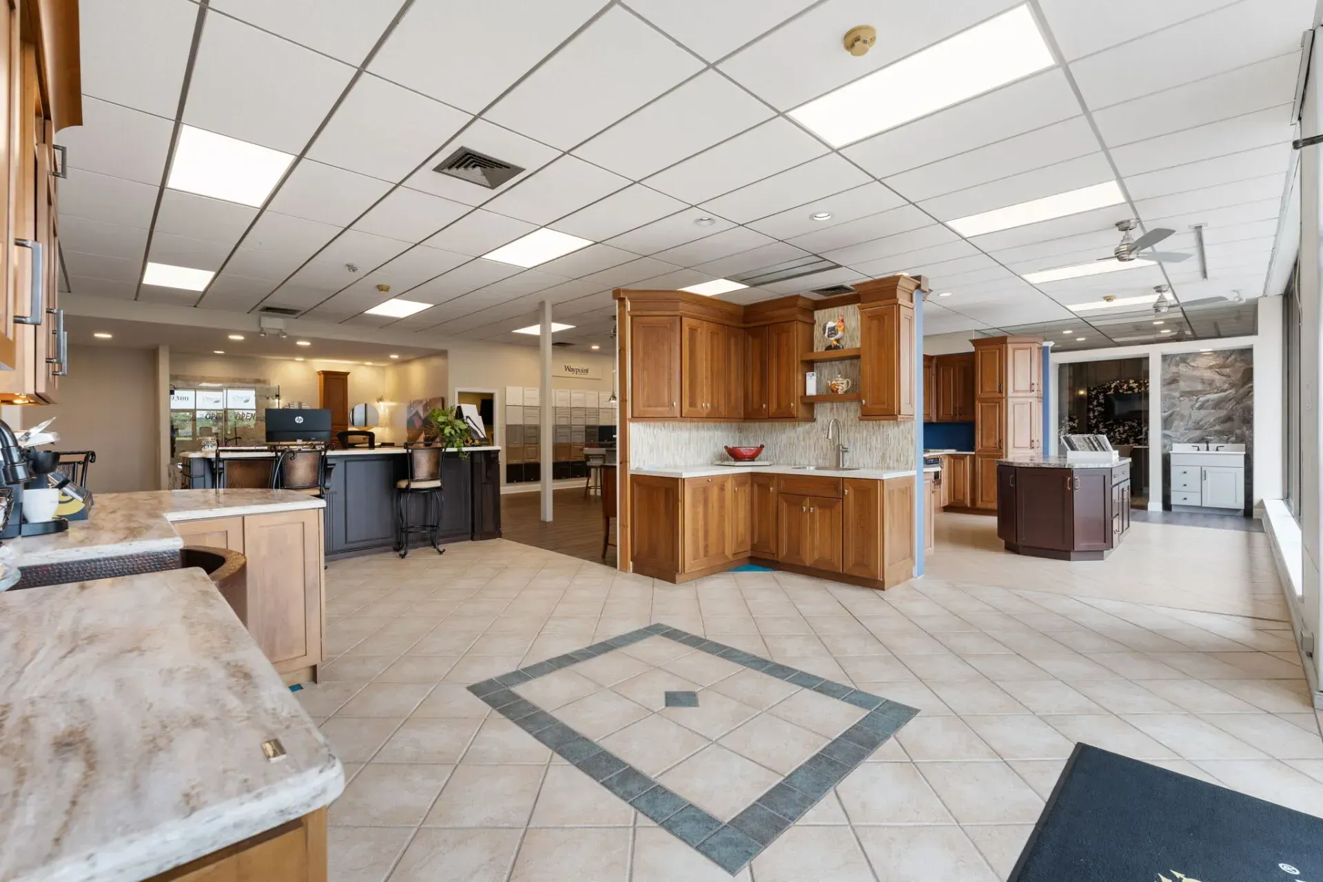 Empty office lobby with tiled floor, wood reception desk, and fluorescent ceiling lights  In Bucks County PA