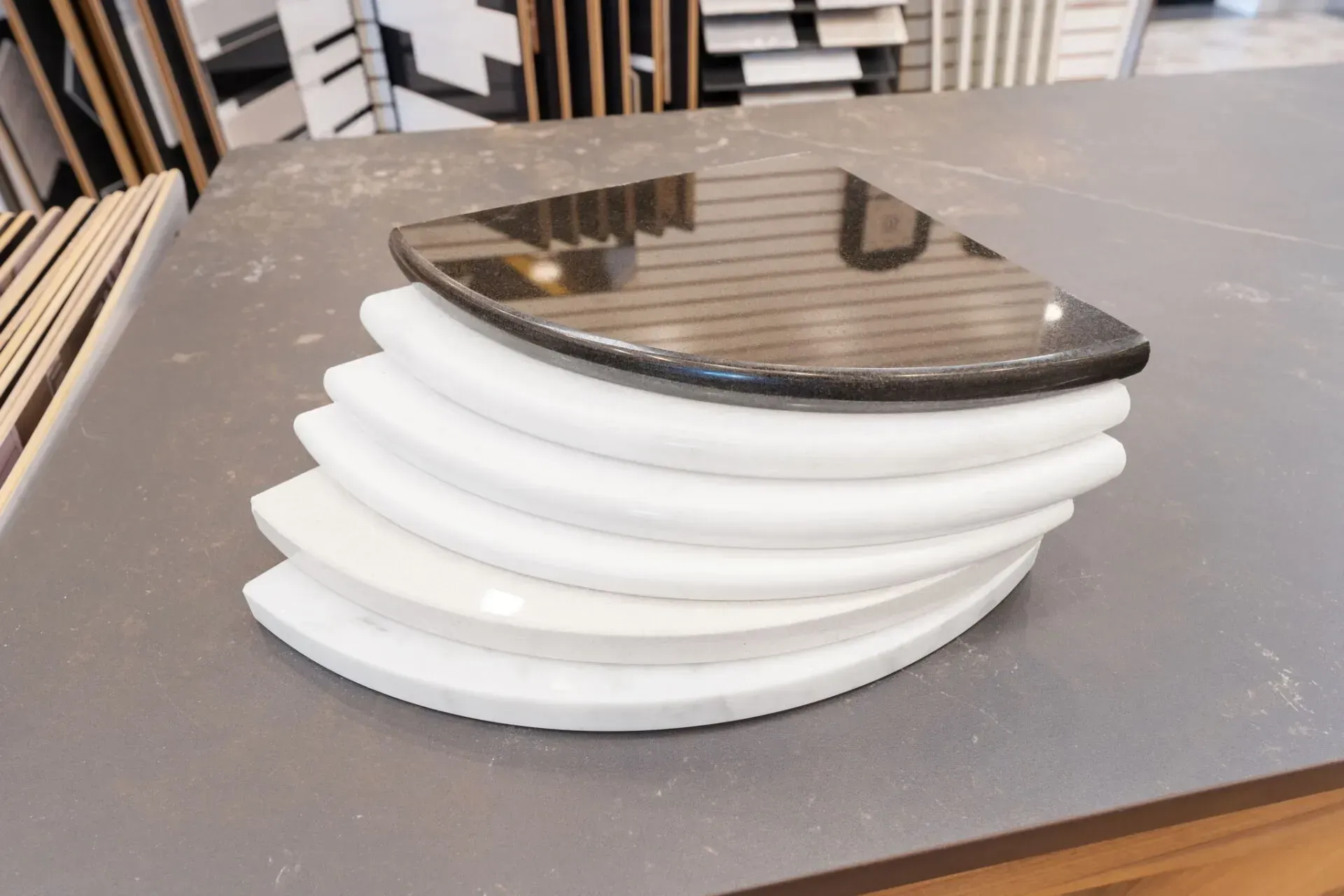 Stacked white plates topped with a reflective dark plate on a table  In Bucks County PA